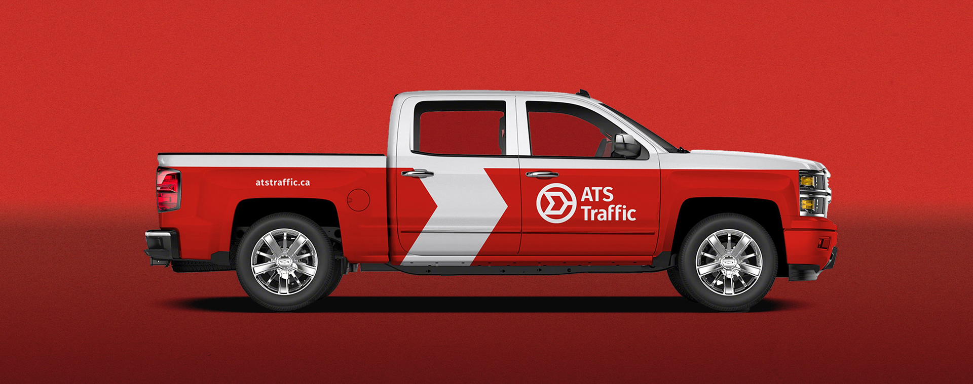 Pickup truck covered in a large chevron shaped graphic. ATS Traffic logo adorns the side door.