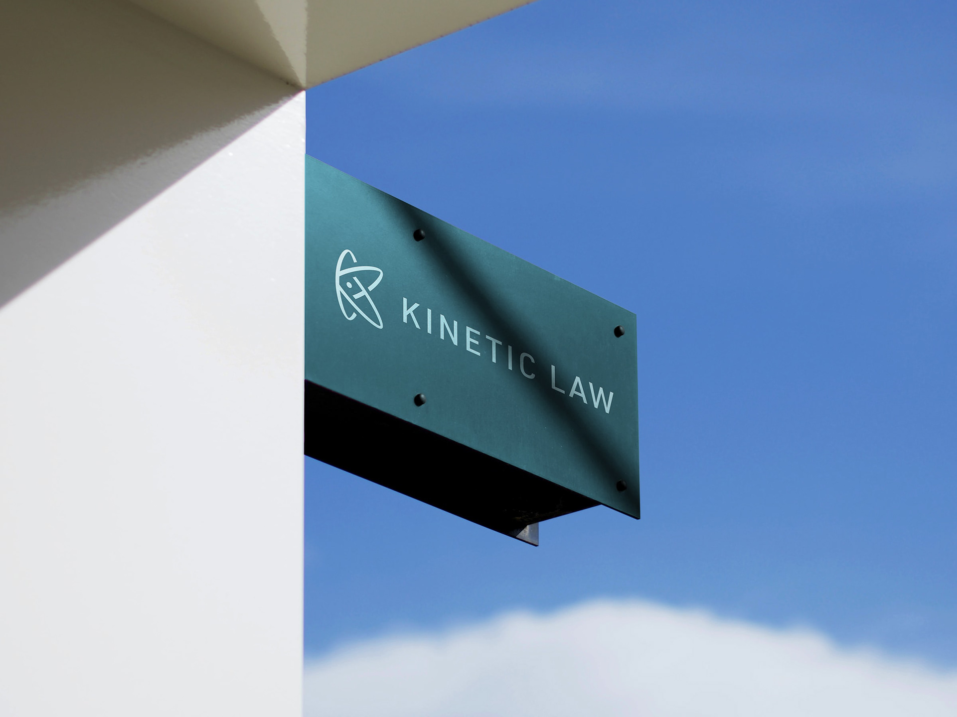 The Kinetic Law logo on a metal sign.