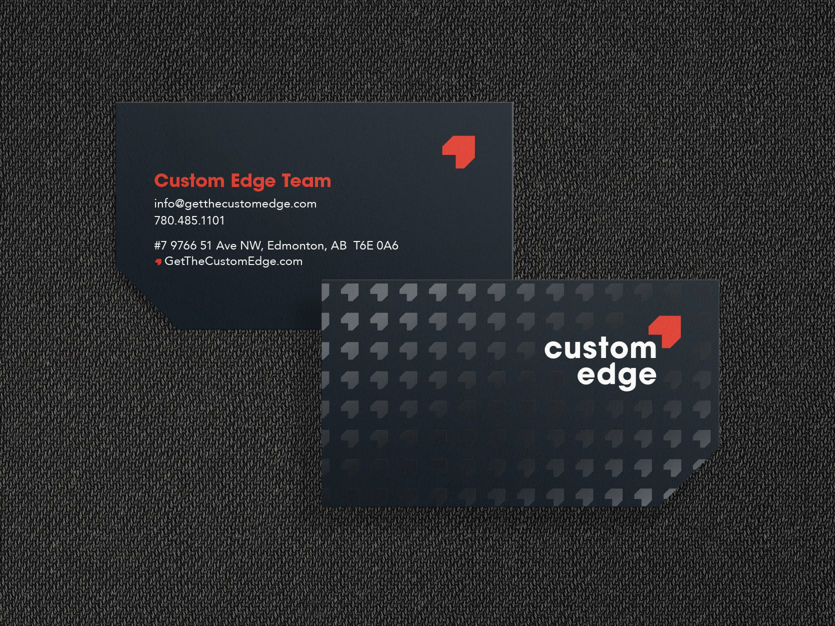 Custom Edge business card. One bottom corner has a 45 degree cut corner, the back side has a spot UV printed pattern.