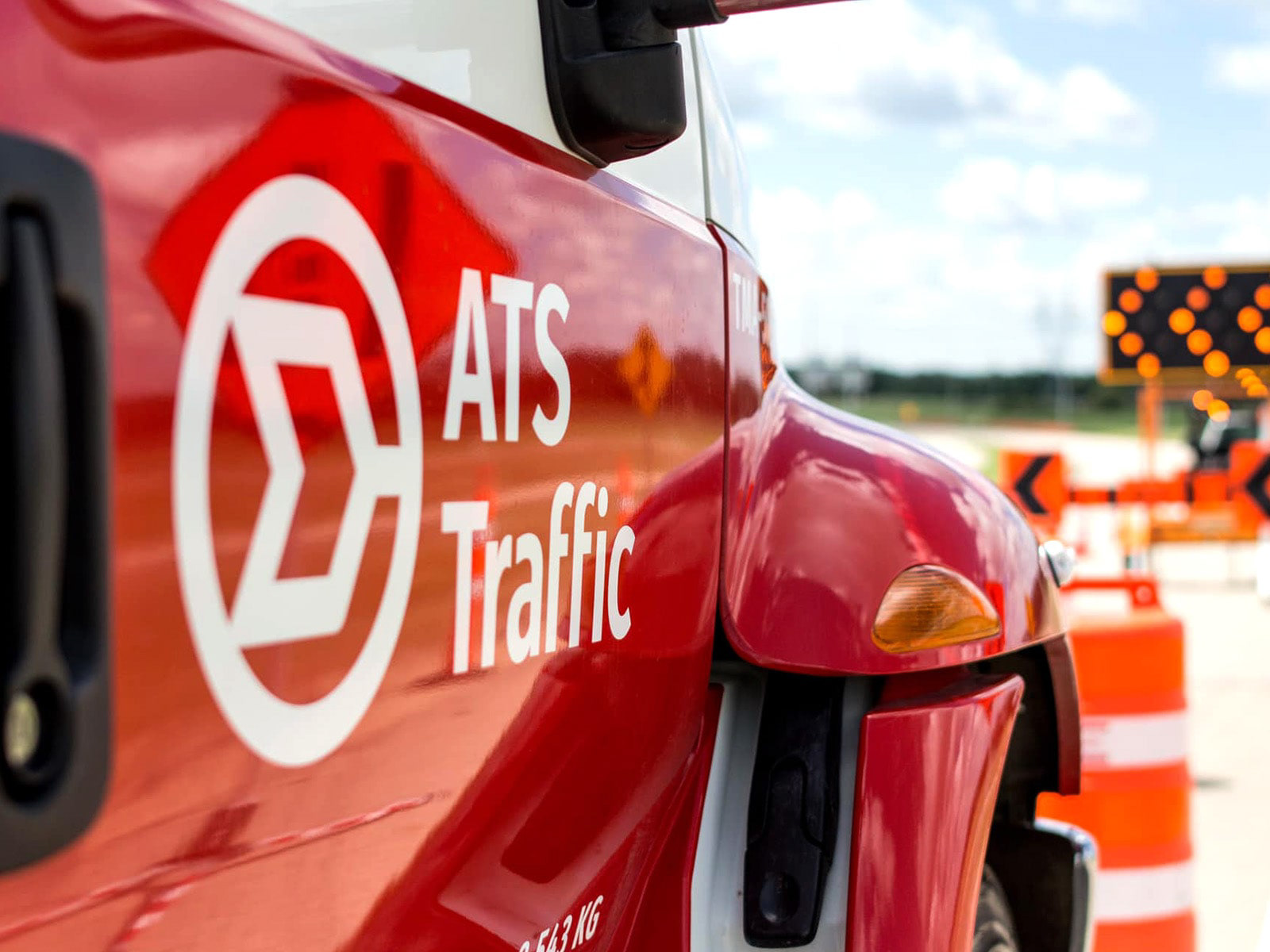 ATS Traffic logo decal on the side of a truck doing road construction.