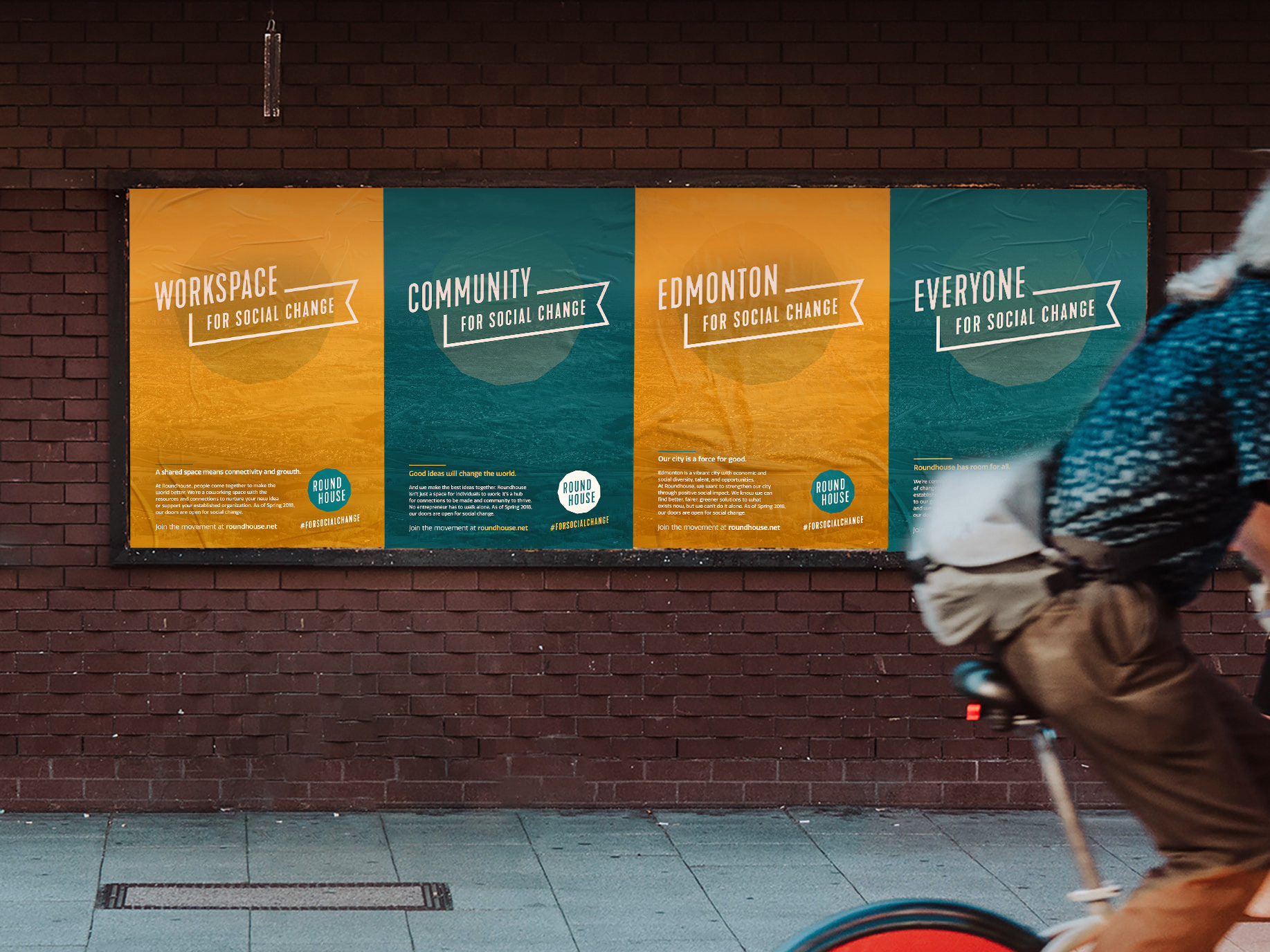 4 Roundhouse posters on an outdoor wall, with taglines "workspace, community, edmonton, and everyone, for social change"