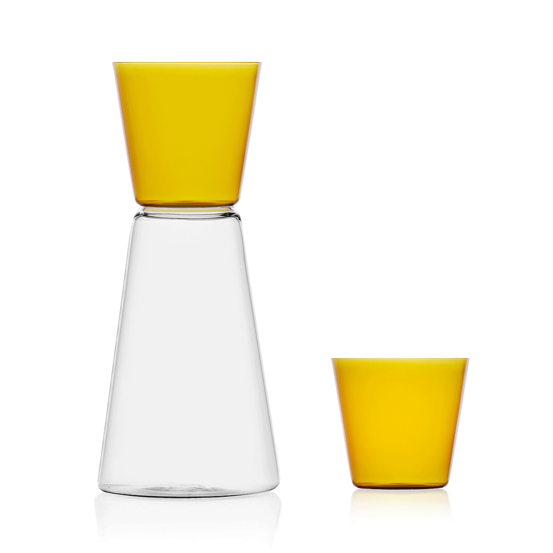 A glass vessel sits next to a matching glass cup with different colours changing via animation.