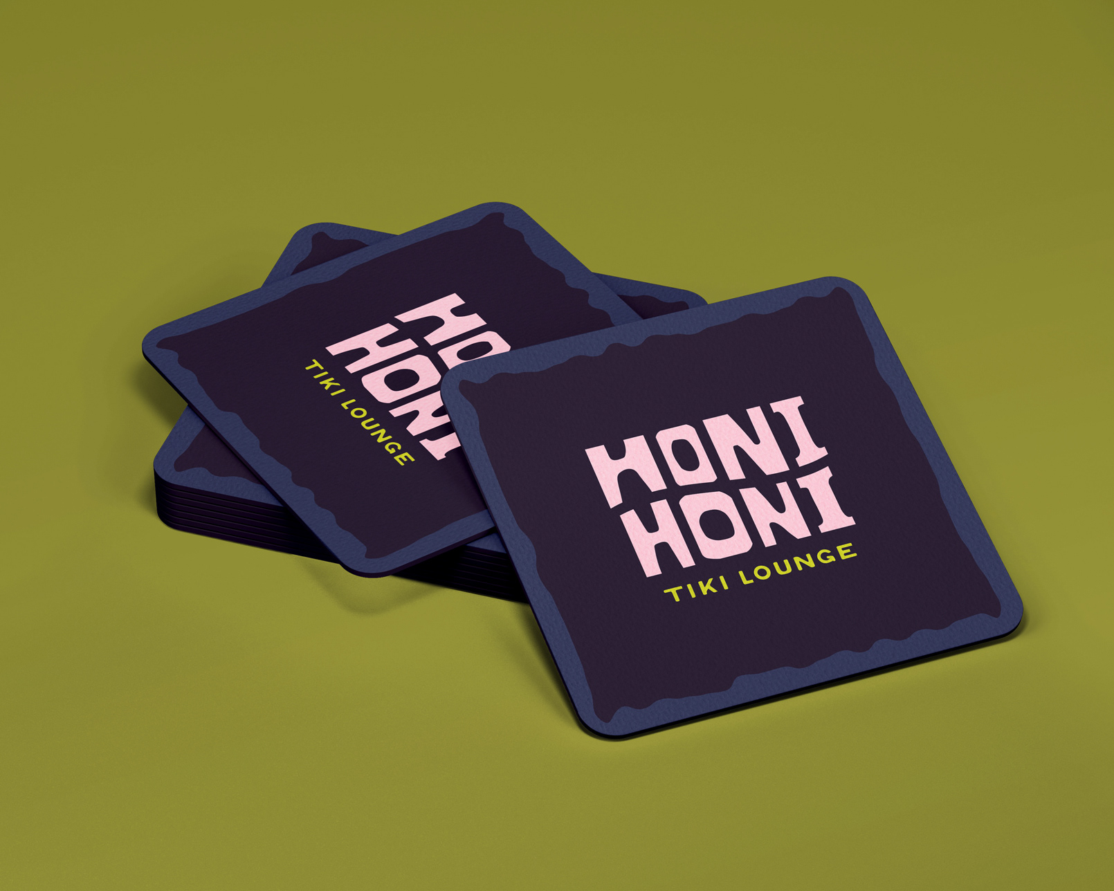 A stack of square coasters with rounded corners with the Honi Honi logo in the centre.