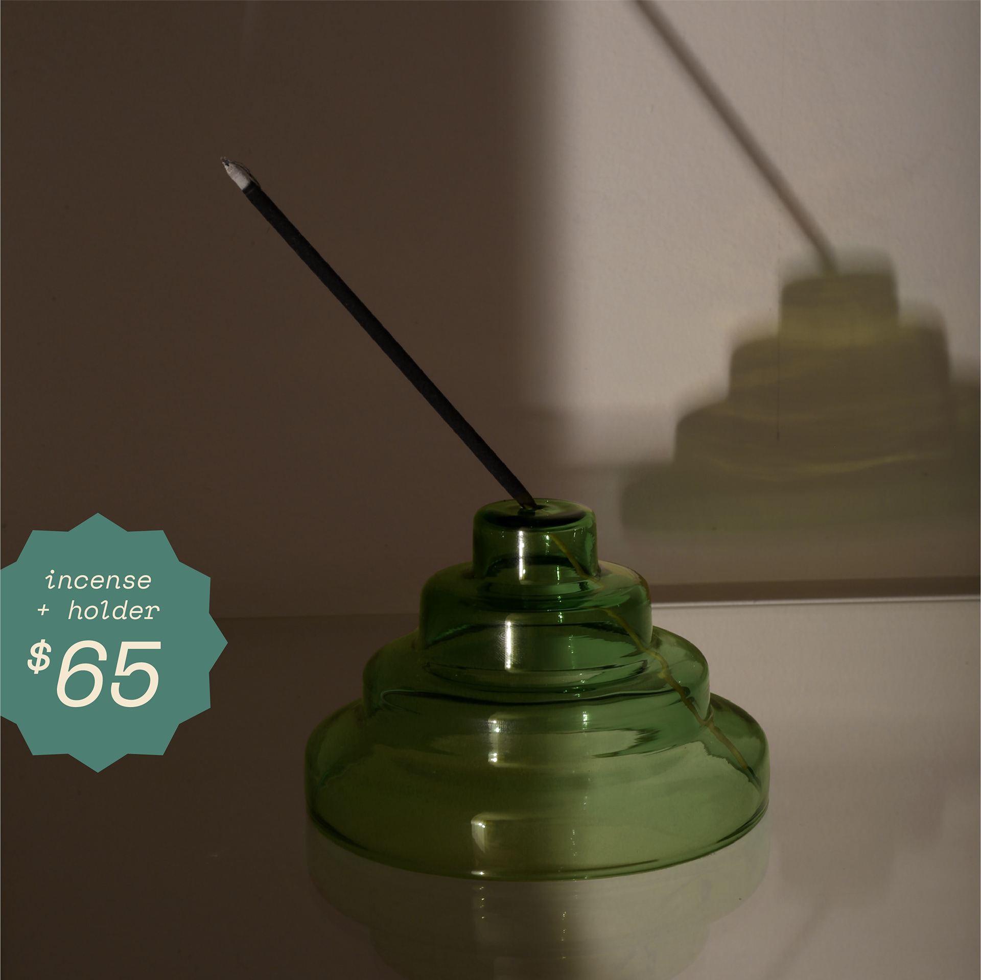 Incense burner in the shape of a cylindrical pyramid. A starburst shape containing text "incense and holder 65 dollars"