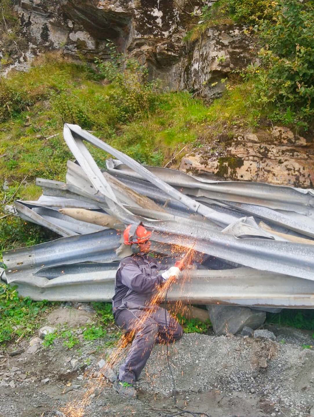 Angle-grinding the crash barriers we salvaged from the landslide in order to make the sculptures in our final installation / Copyright © Christopher Pearson 2019