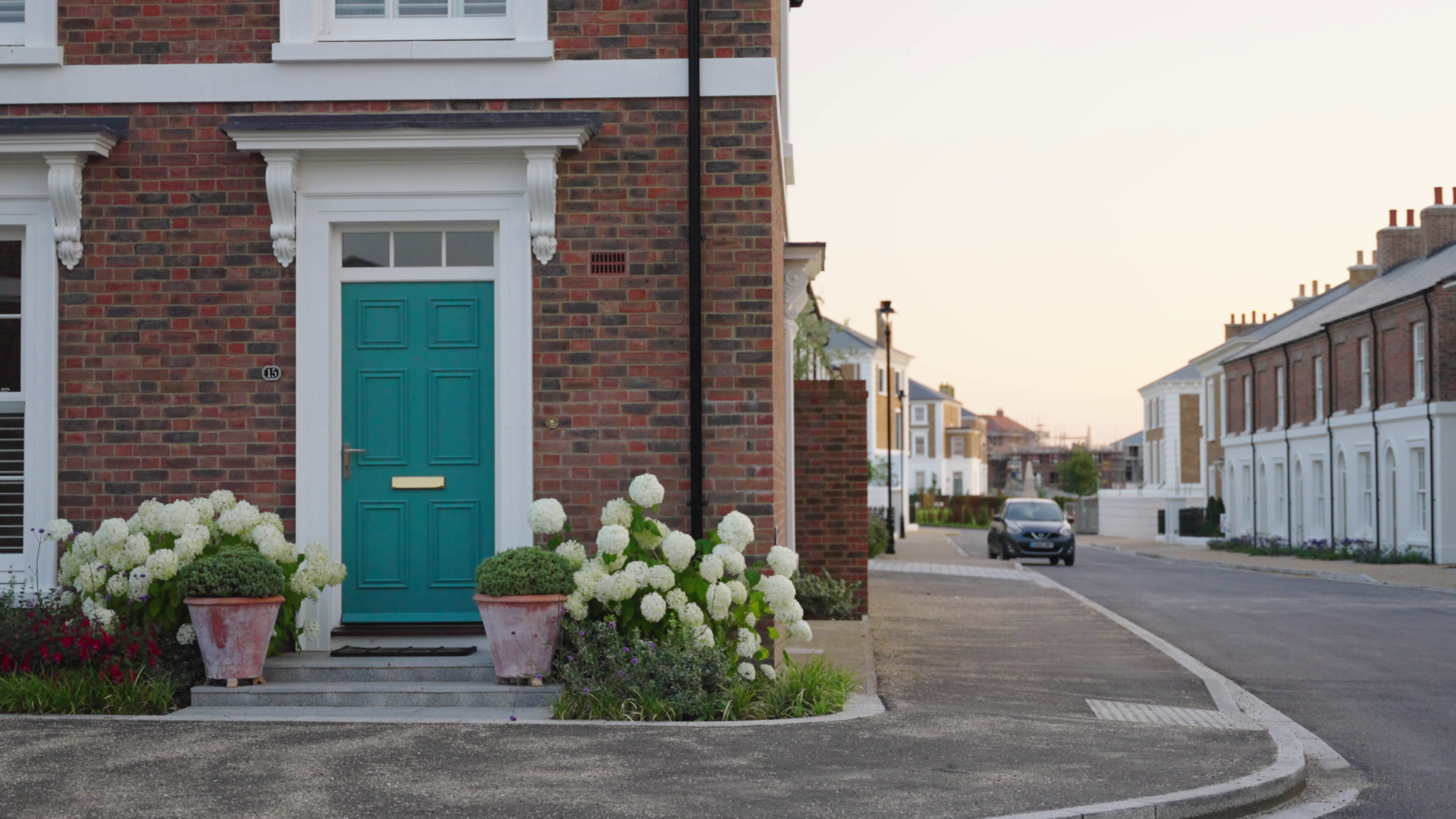 doorway with hydrangeas on street at sunset
