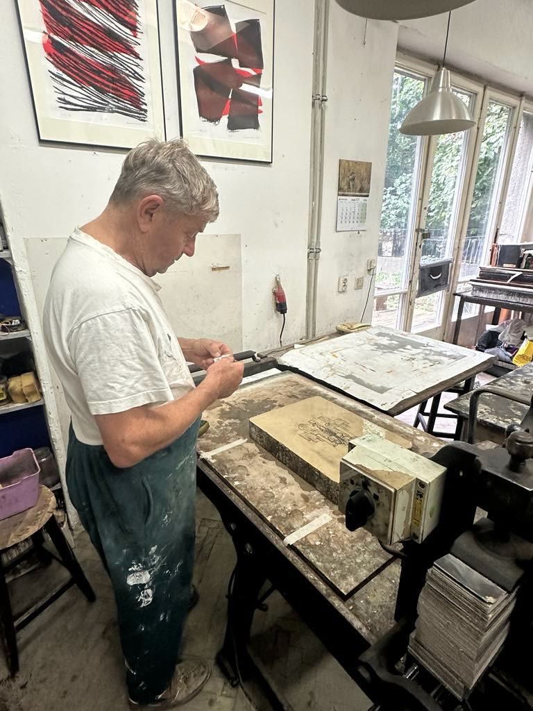 Artist Piotr Kasprzak preparing to make first print.