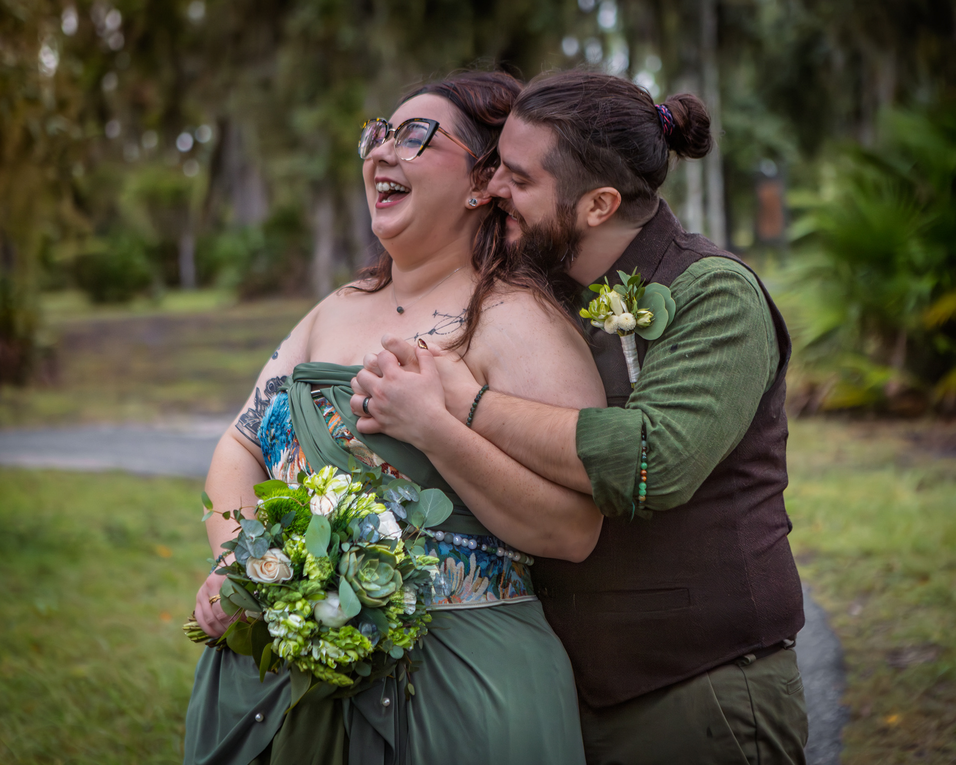 Bride laughing while groom whispers in her ear at their wedding at Riverwalk Park, St. John River