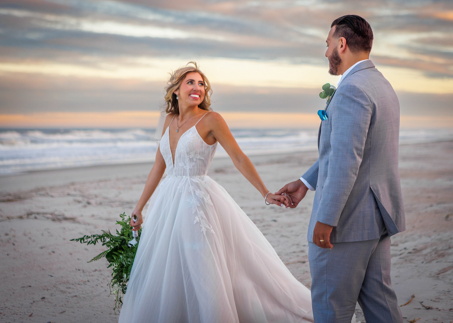 Bride & Groom walking at the beach during sunset  at their Ponte Vedra Inn & Club wedding