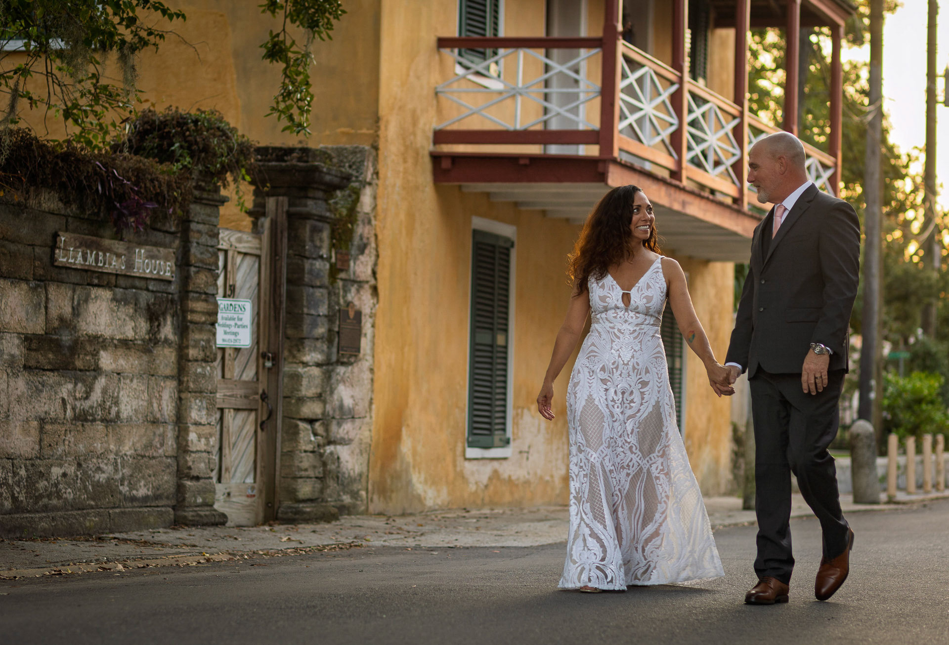 Newlyweds holding hands  at their Downtown St. Augustine wedding photographer
