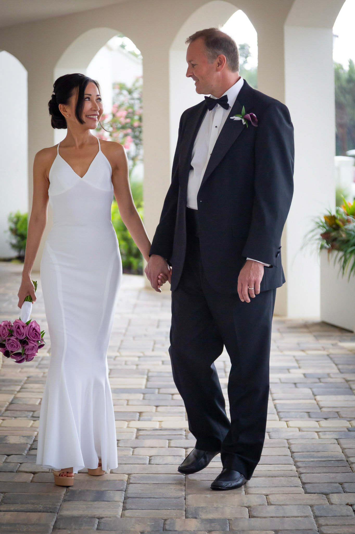 Bride & Groom walking through the arches at The Lodge & Club, Ponte Vedra Beach wedding photography