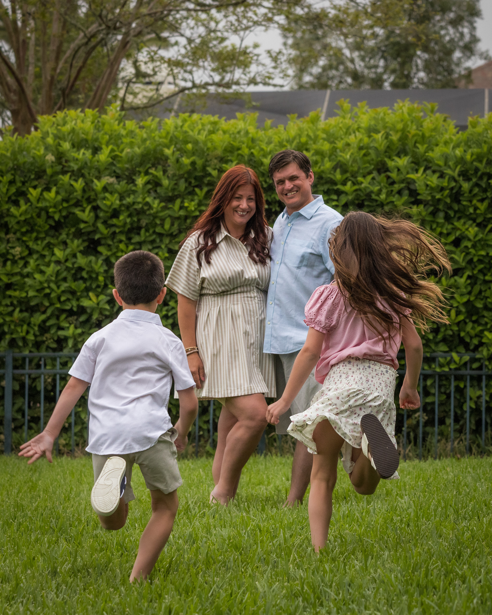Fun and lifestyle family portrait session in Ponte Vedra Beach with parents and kids playing outdoors