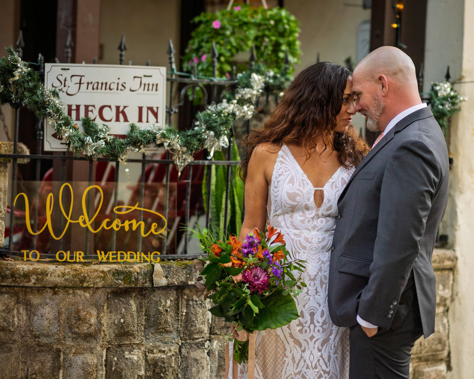 Bride and Groom embracing at St. Francis Inn, St. Augustine wedding