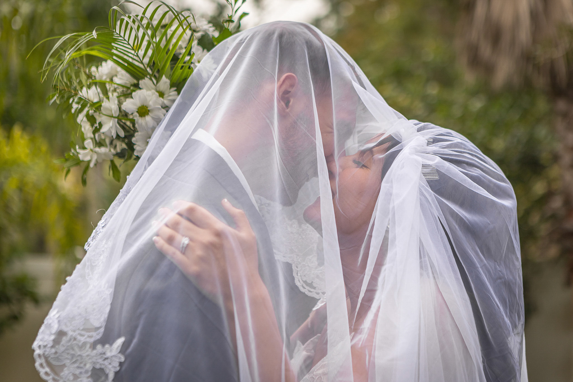 Close-up of  Bride and Groom kissing under the flowing white veil, Jacksonville Wedding Photography