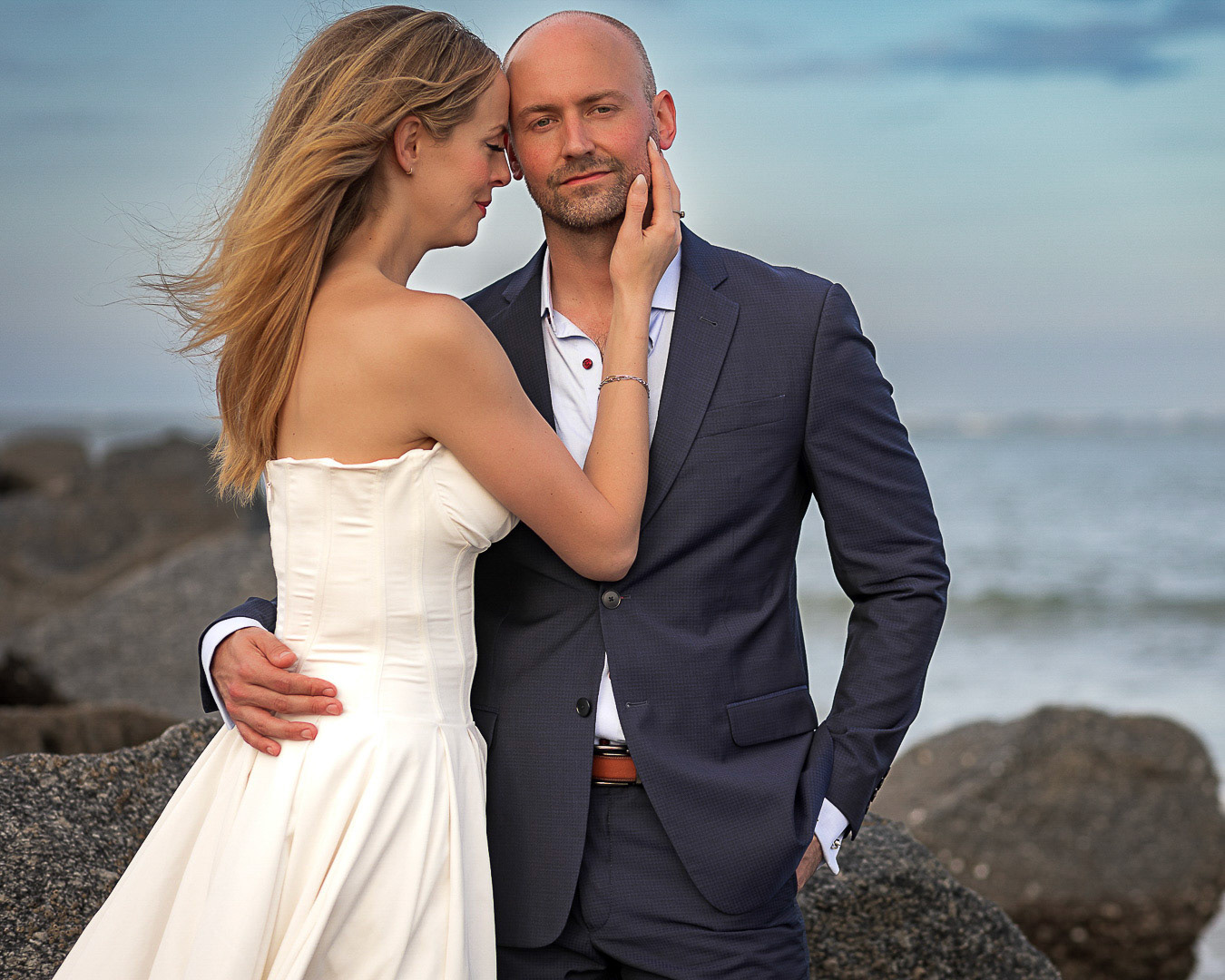 Bride and Groom embracing  at their Villano Beach sunset  wedding photography