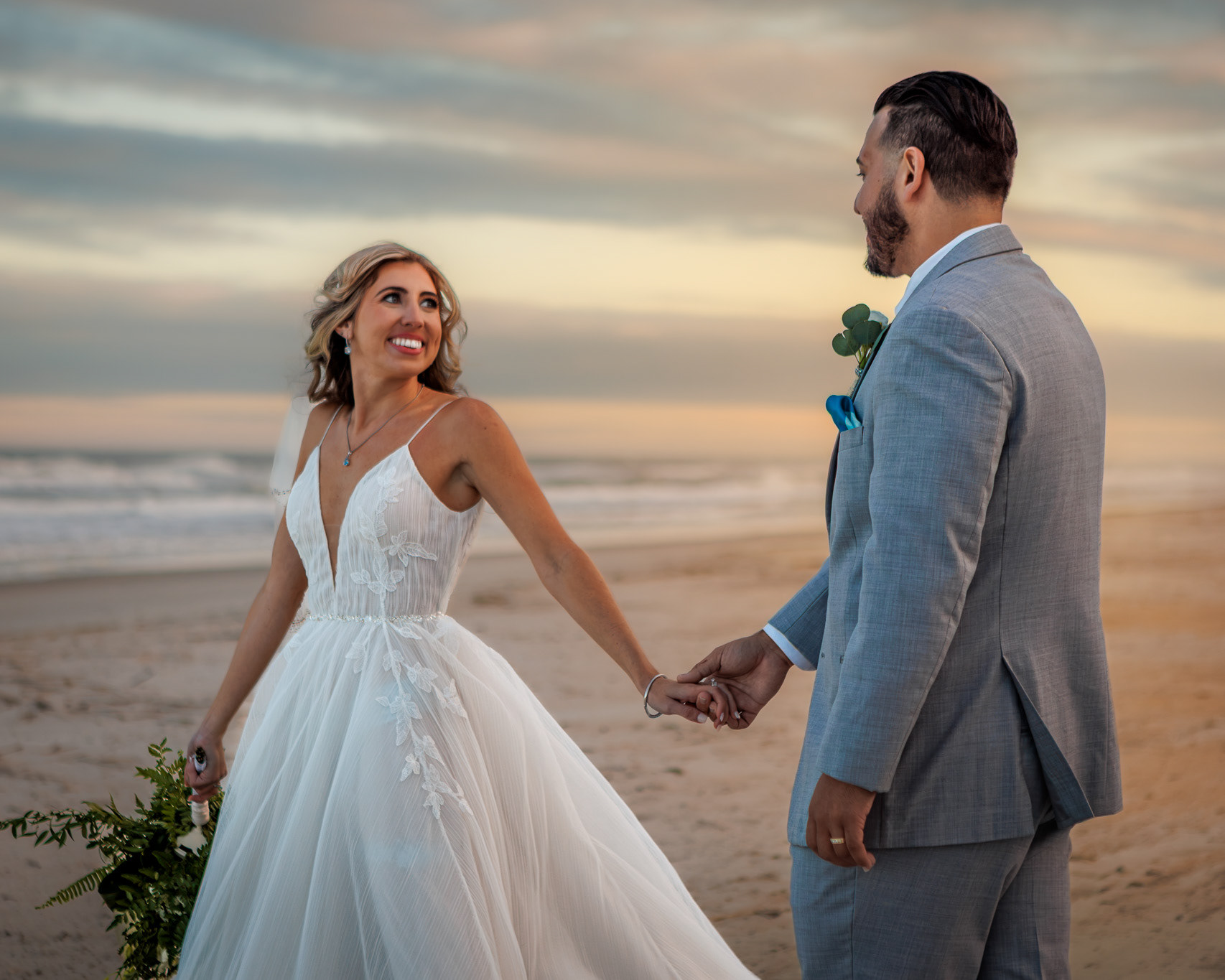 Bride & Groom walking at the beach during sunset  at their Ponte Vedra Inn & Club wedding portrait