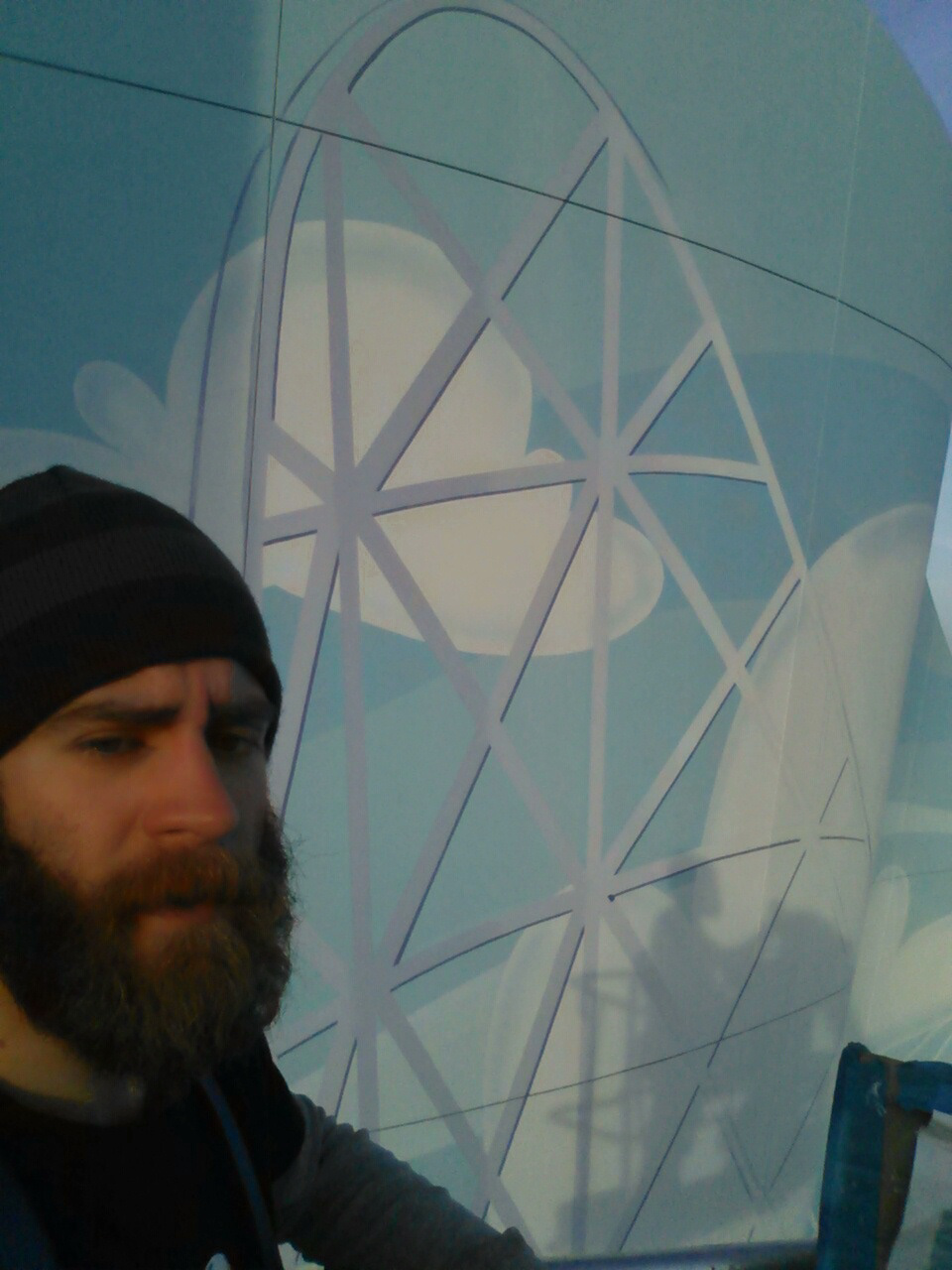 Hand Painting the mural out of a cherry picker