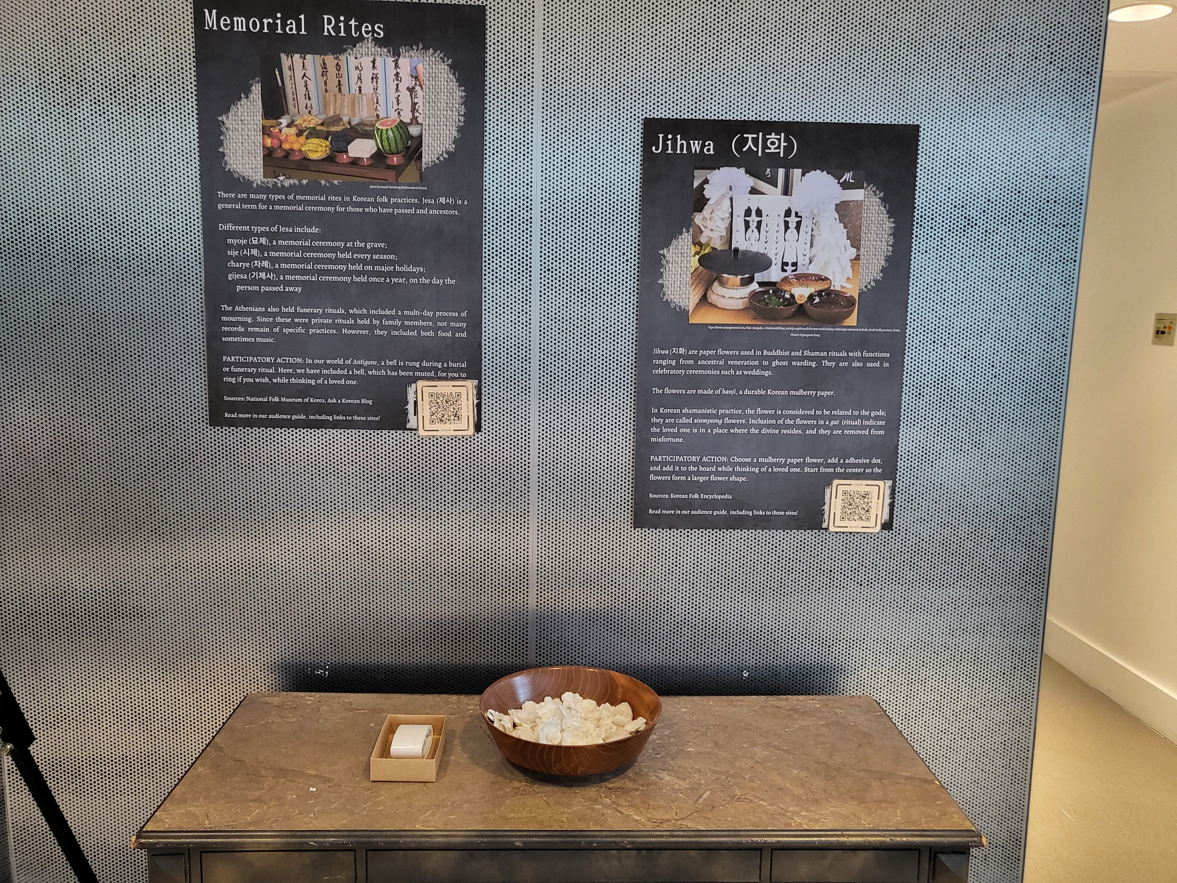 Poster and paper flowers below for guests to remember the dead.