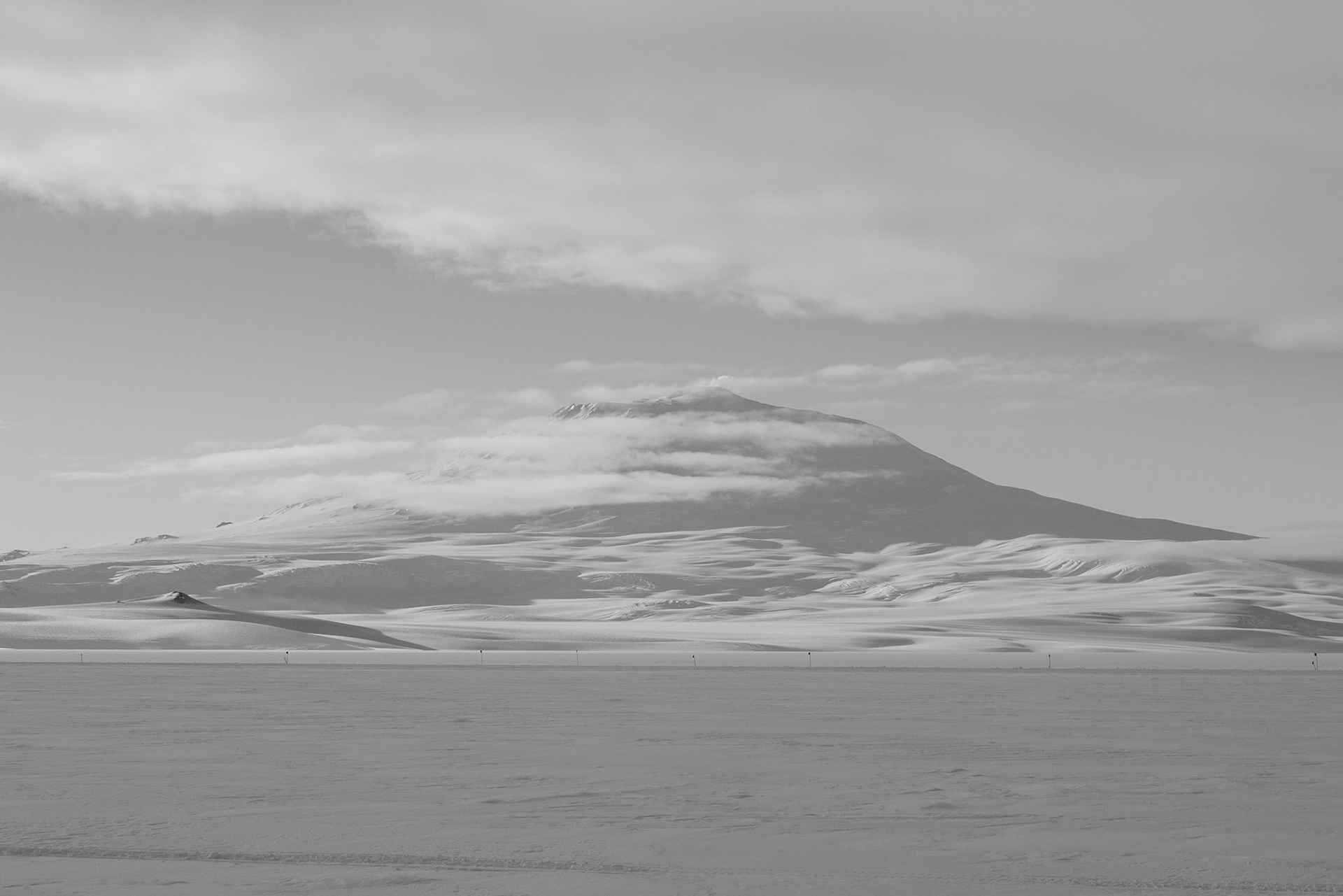Mount Erebus with a little smoke at the top. On the ice shelf laying hose to Willy Field.