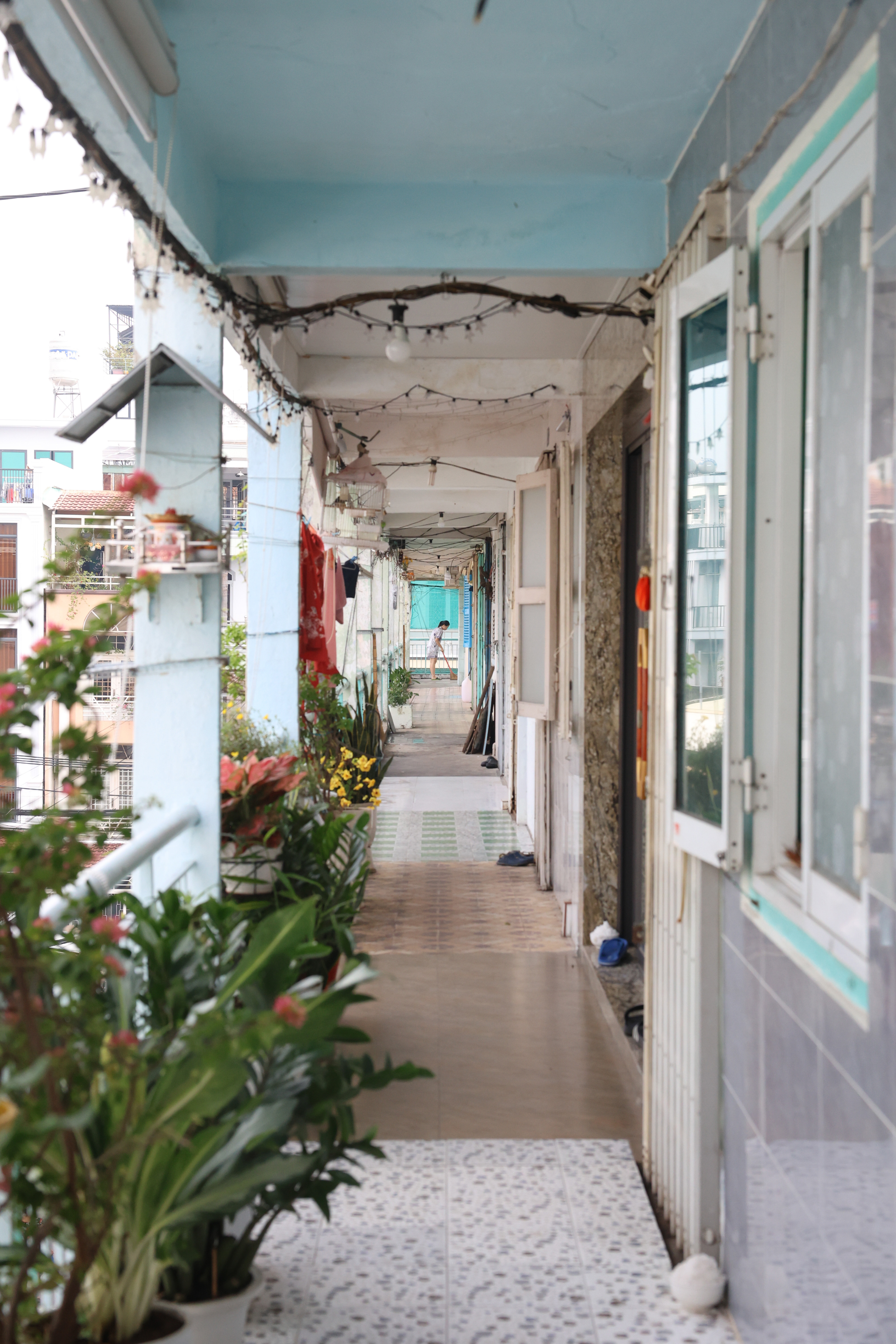 A woman sweeps the hallway in Nguyen Thien Thuat, also nicknamed “old apartments” in Ho Chi Minh City, Vietnam, on Thursday, Jan. 2, 2025. The apartments were built in 1968 to house US soldiers during the Vietnam War, and are now known to be a hub for retirees, shopkeepers and street vendors.