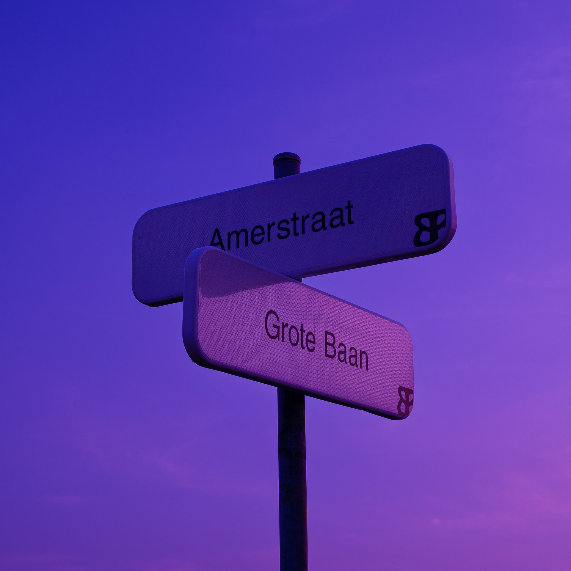 Street signs at sunset