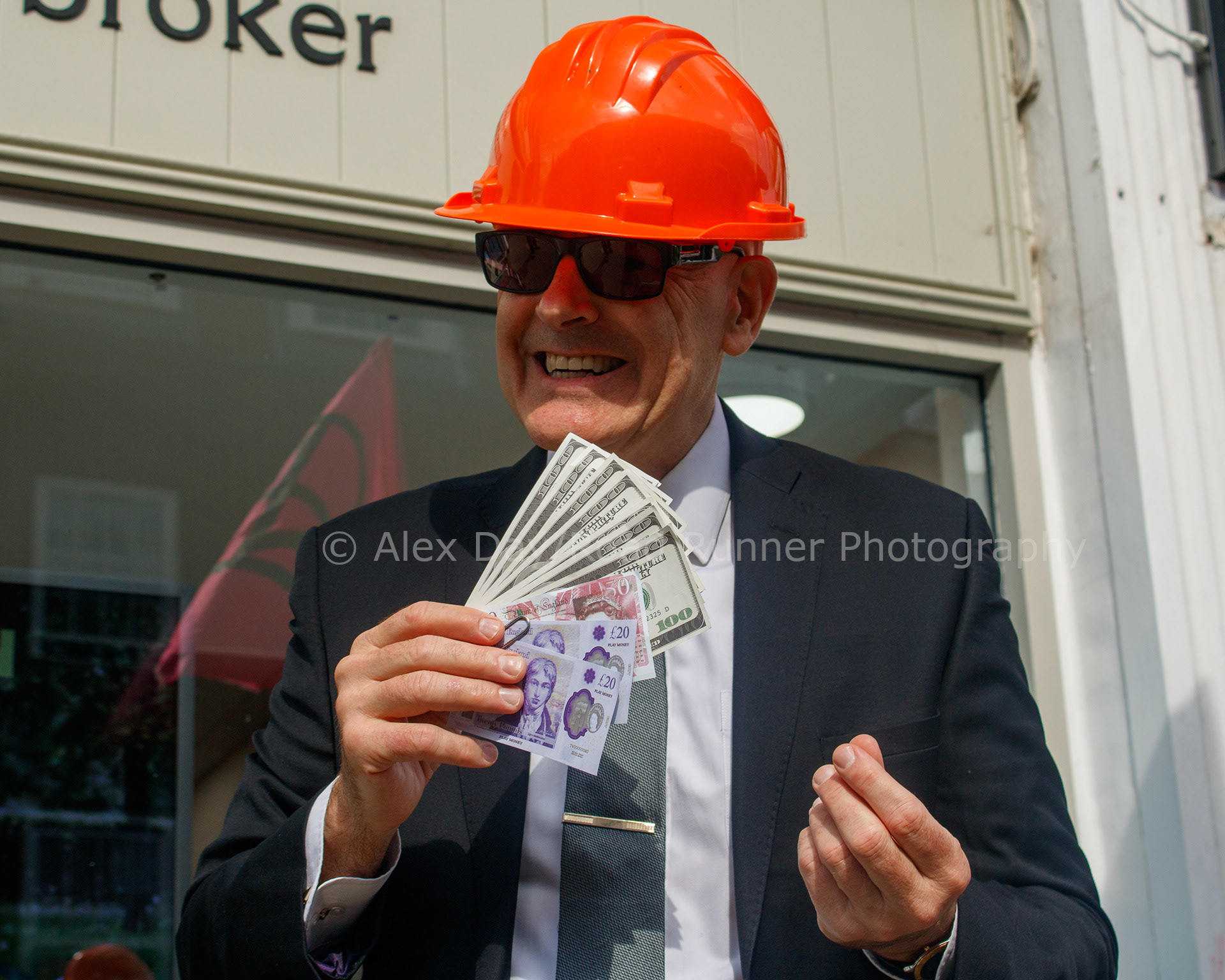 A protest dressed as a insure waves cash