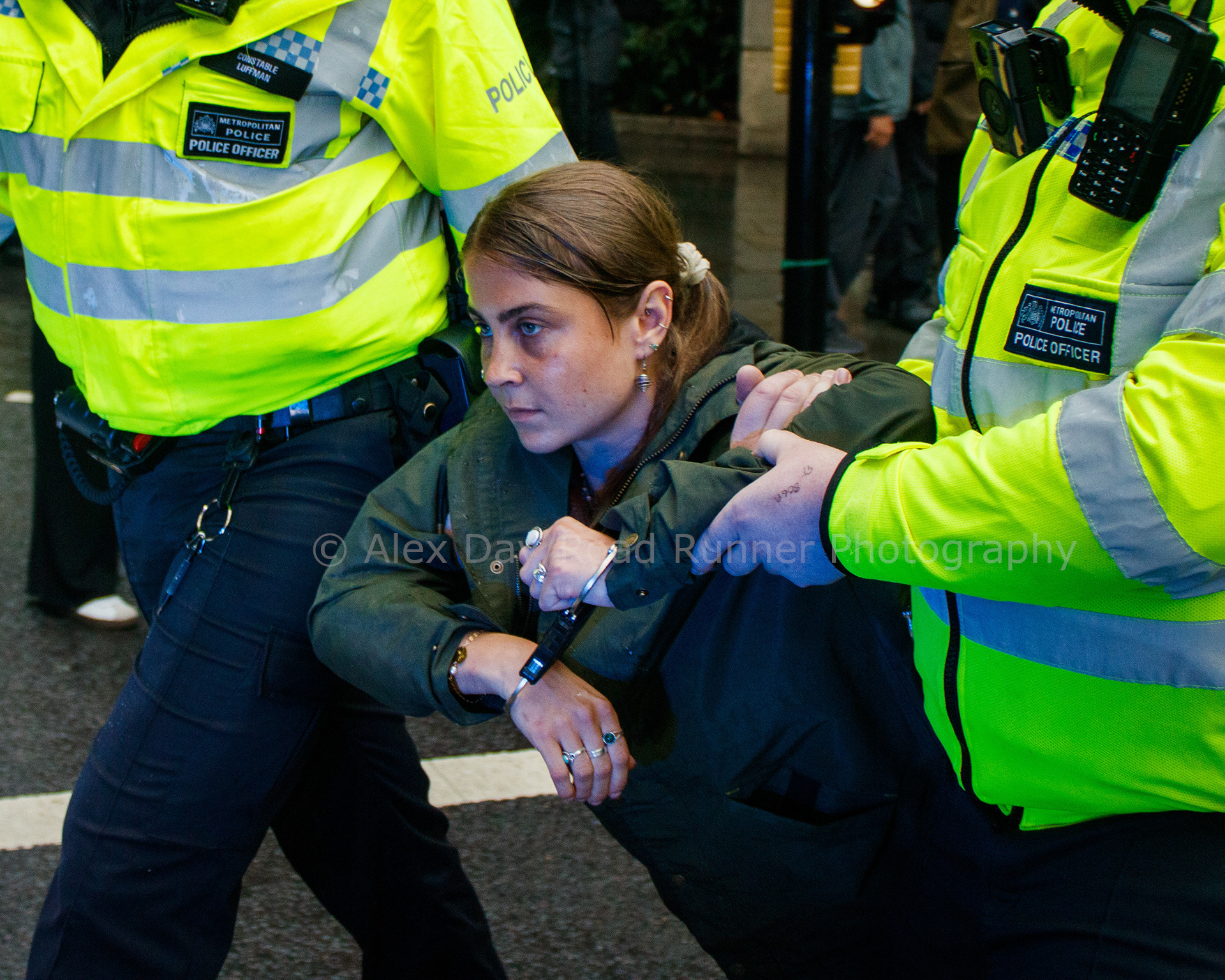 A protester is dragged away by police at a protest in support of Palestine Action