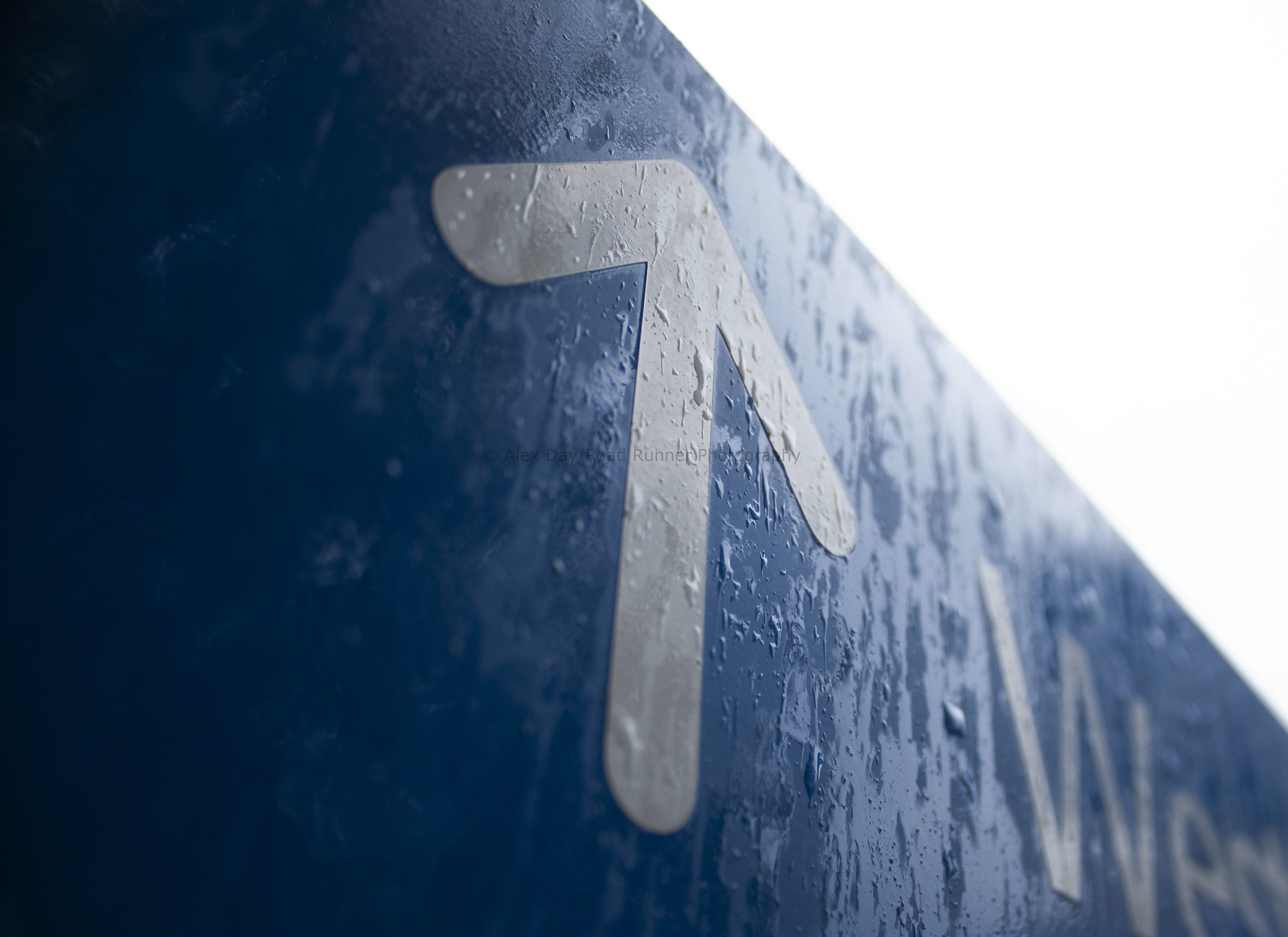 An arrow on a sign in the rain