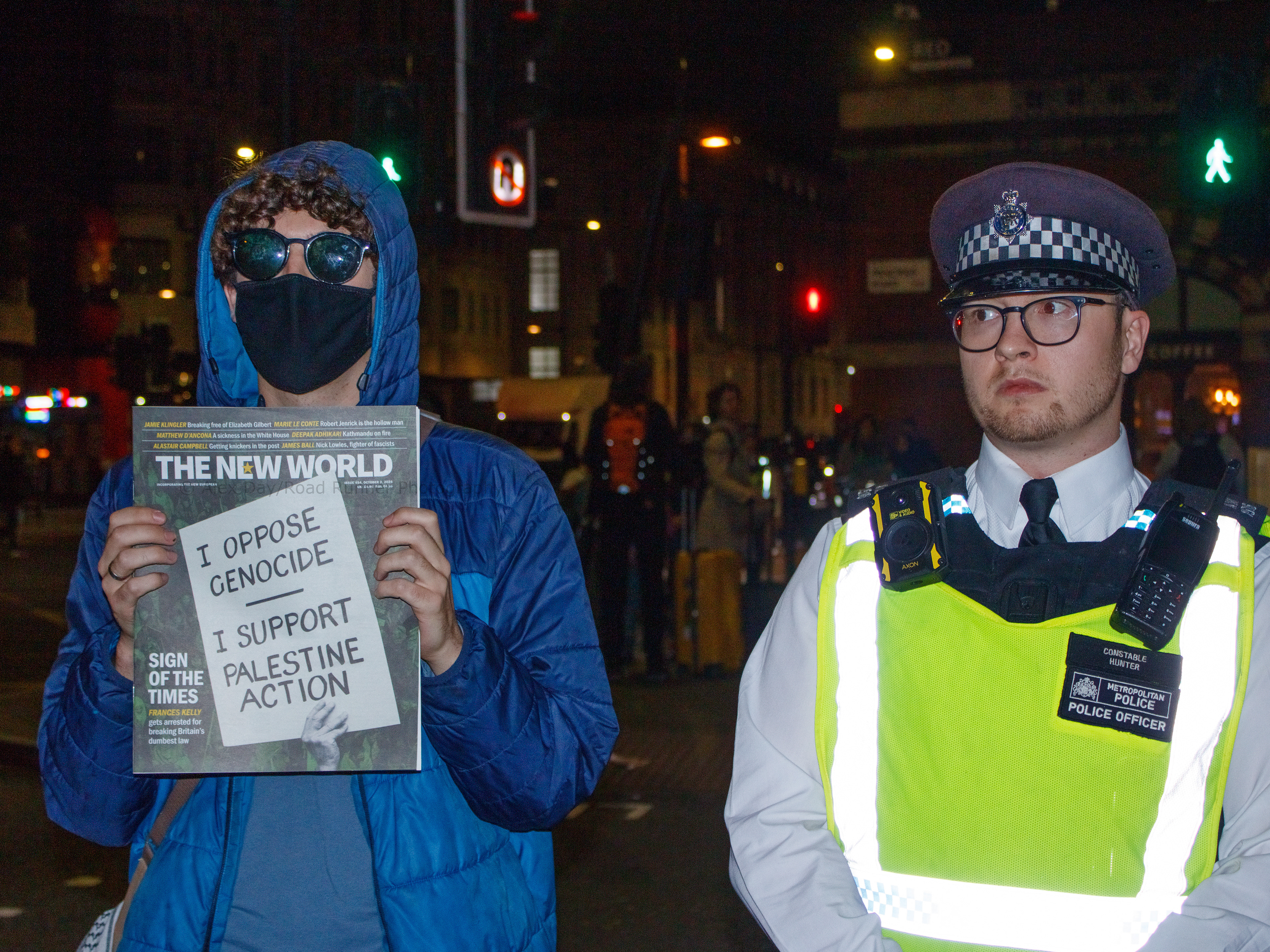 A protester and a police officer stand side by side 