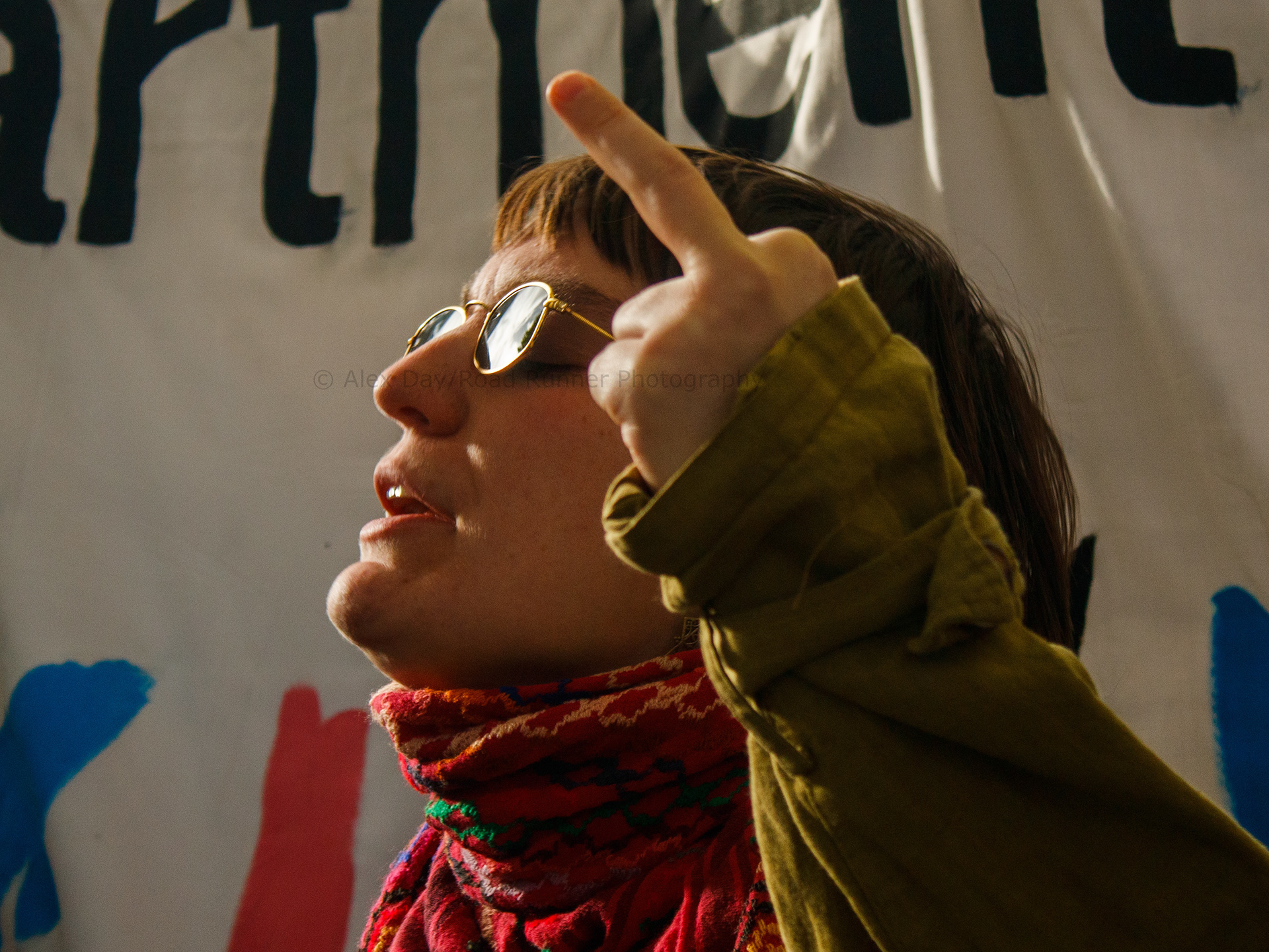 A protester flips off auditors at a transgender rights demo