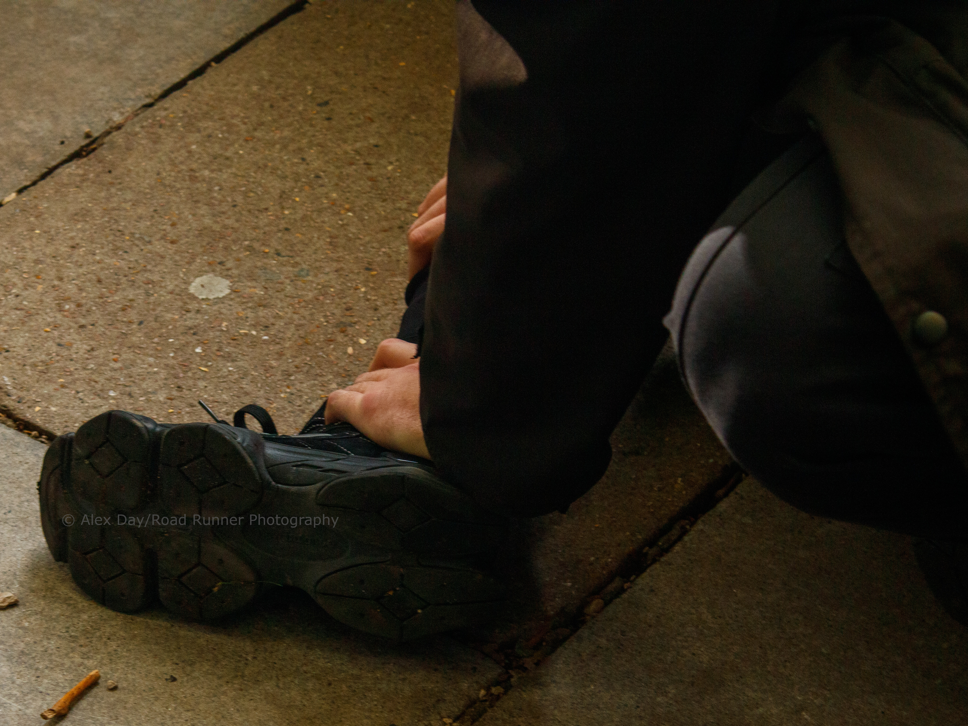 A police officer grabs the foot of a protester at a transgender rights demo