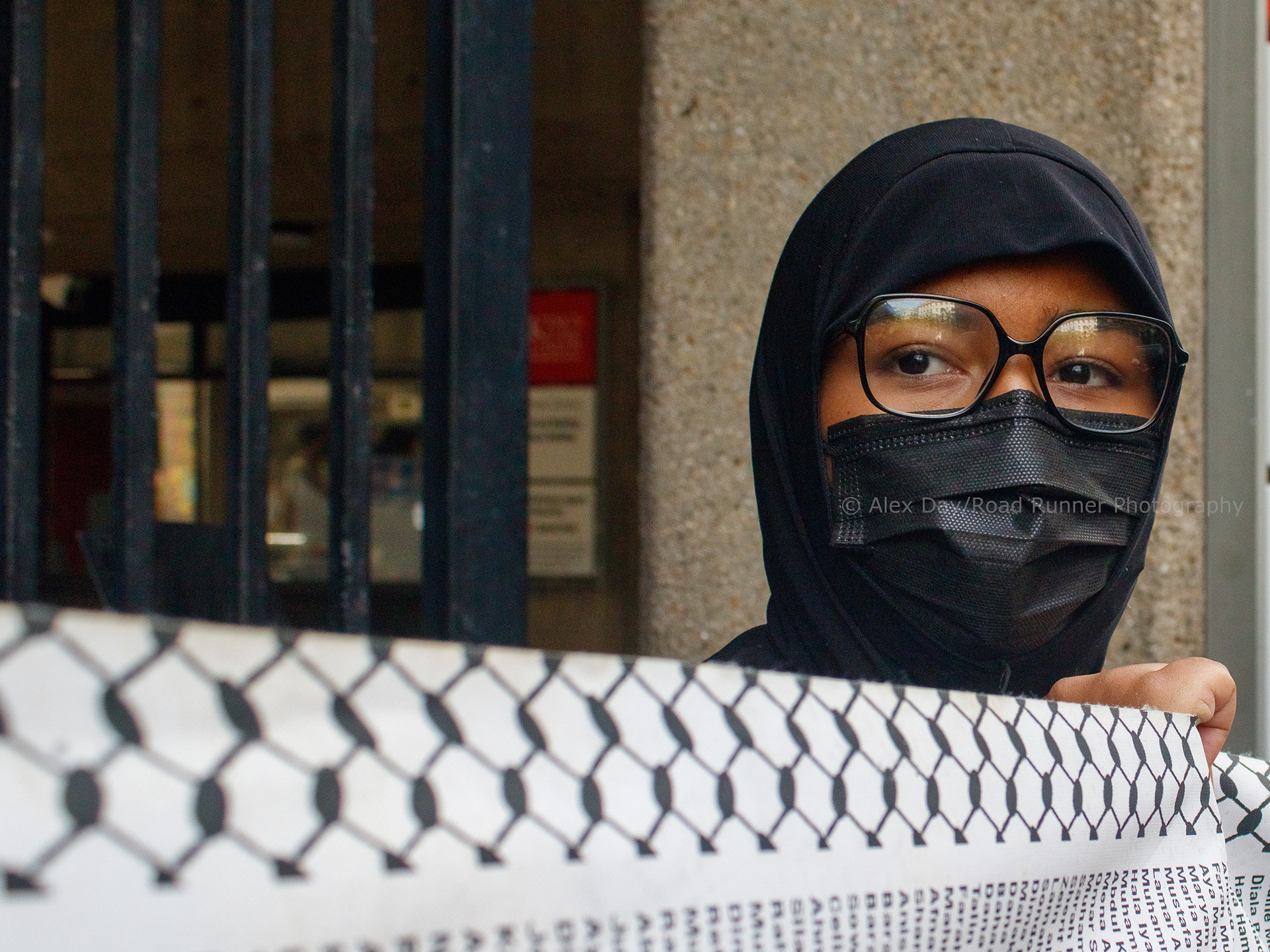 Inter-University protester holding a banner