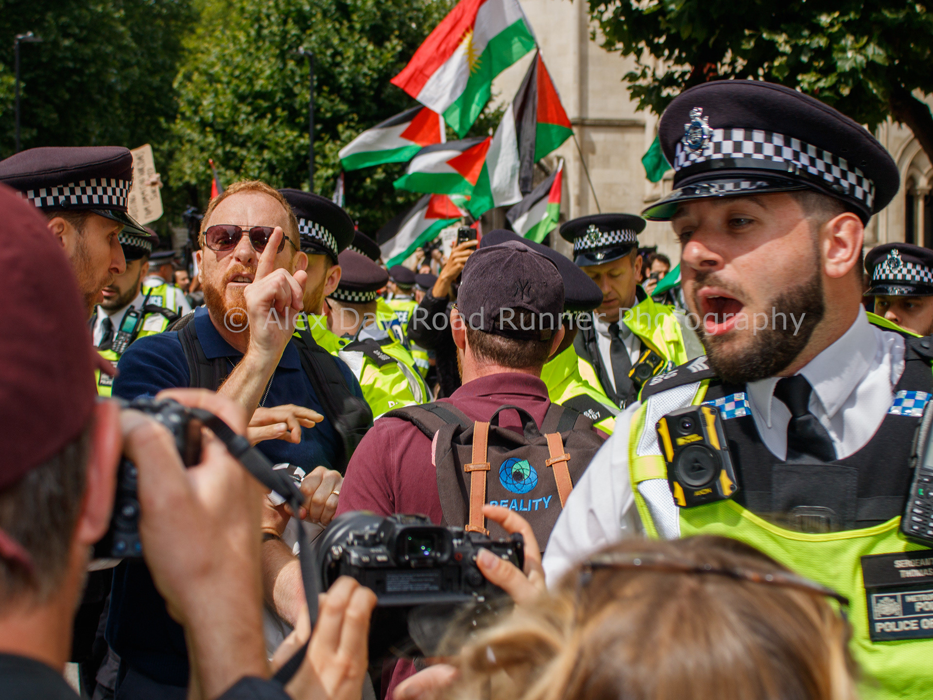 Police clear the way for an Israeli counter protester