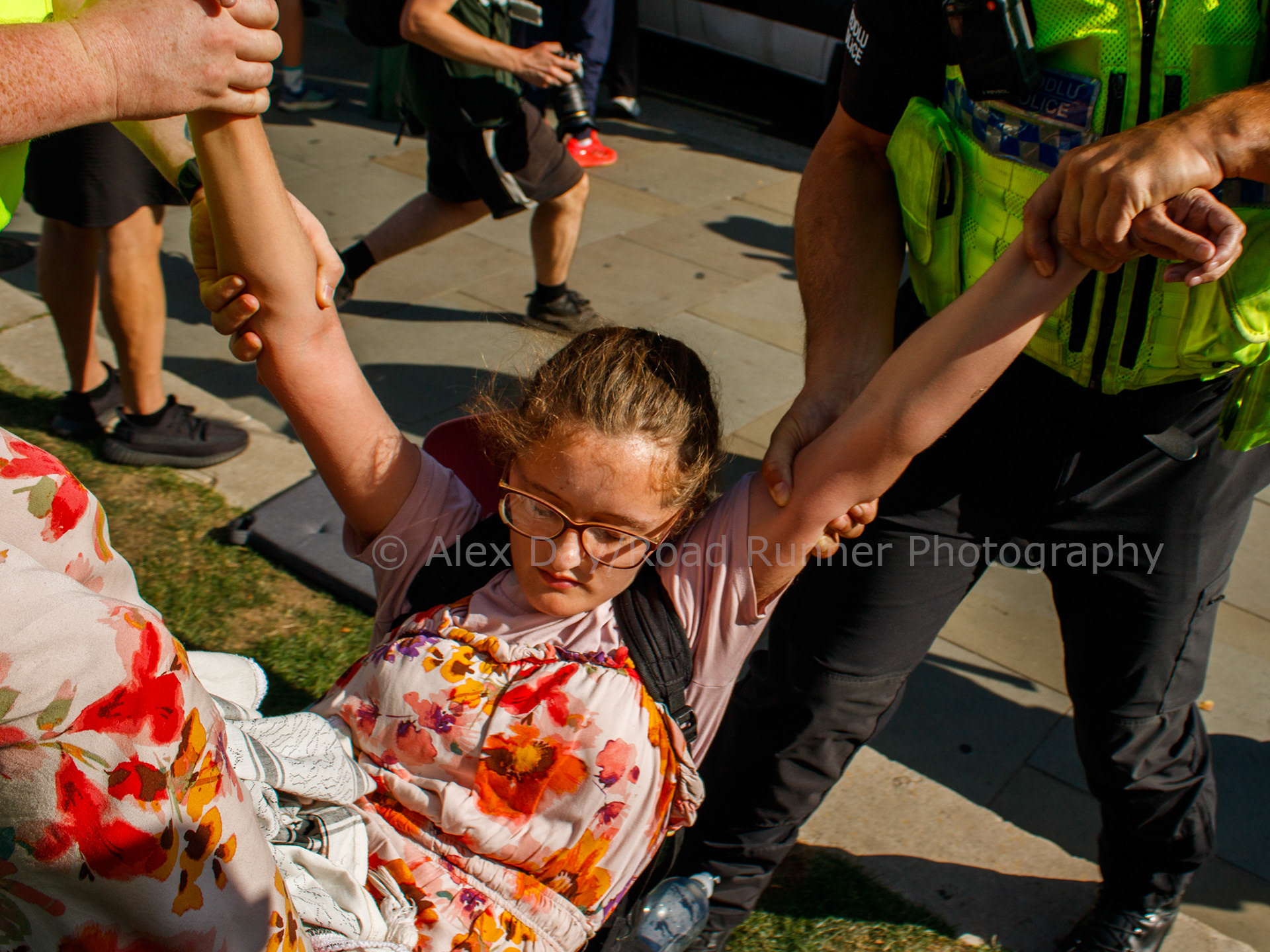 A protester is dragged away by police at a protest in support of Palestine Action