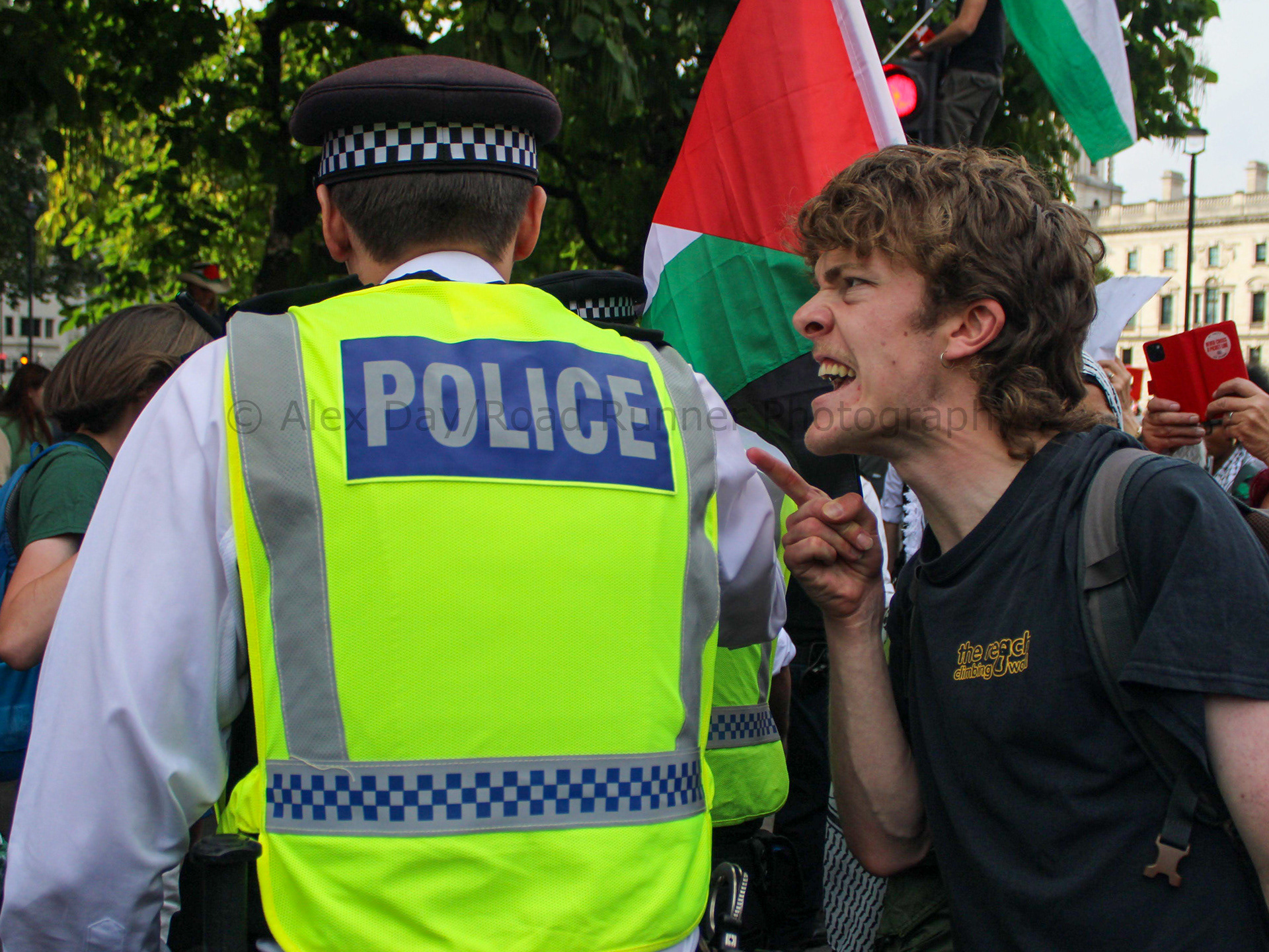 A protester shouts at a police officer