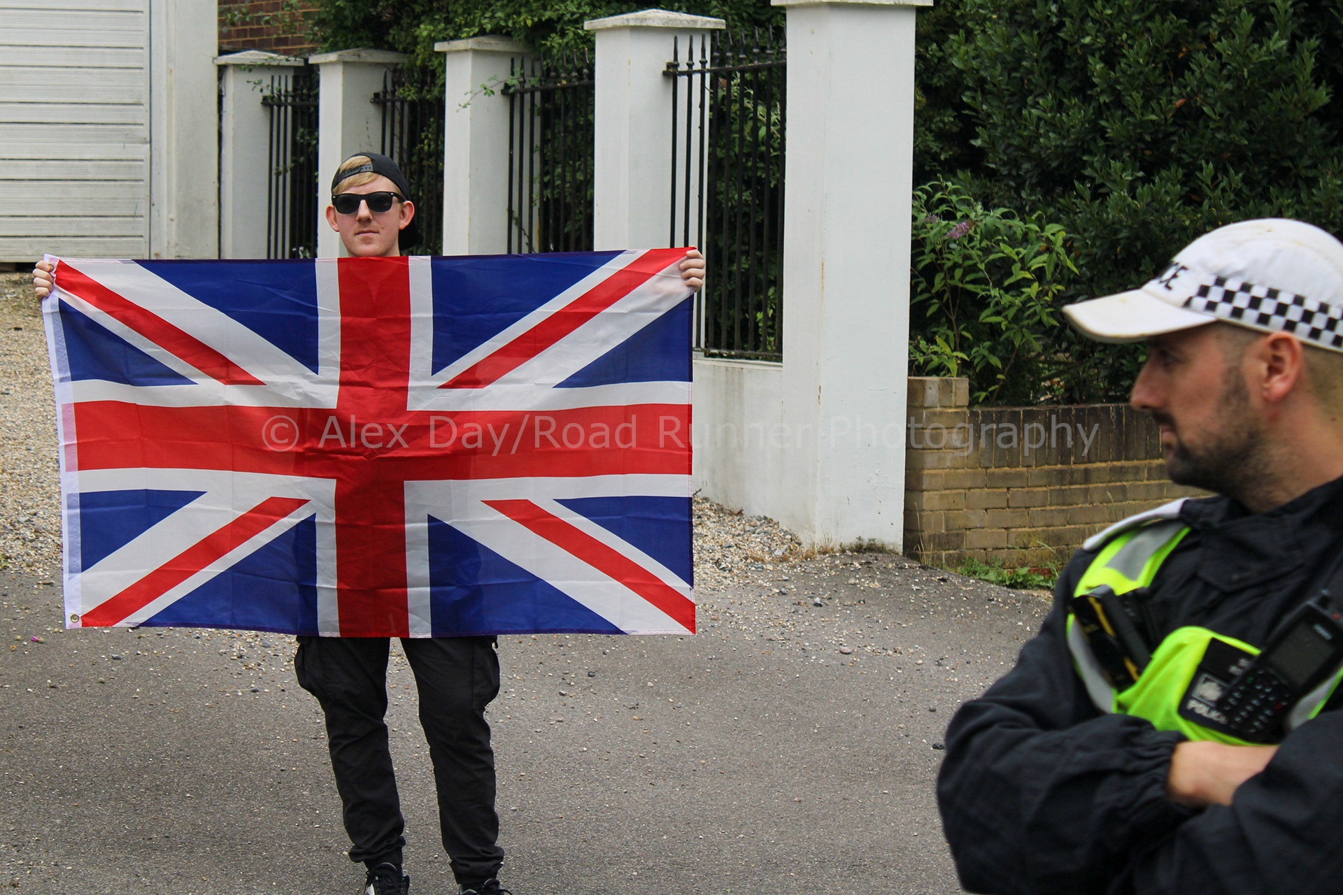 A lone counter protester holds the Union Flag