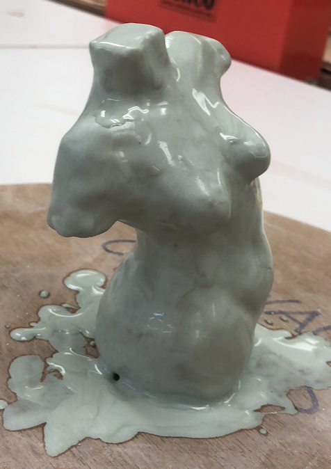 Sculpture painted in white slip.