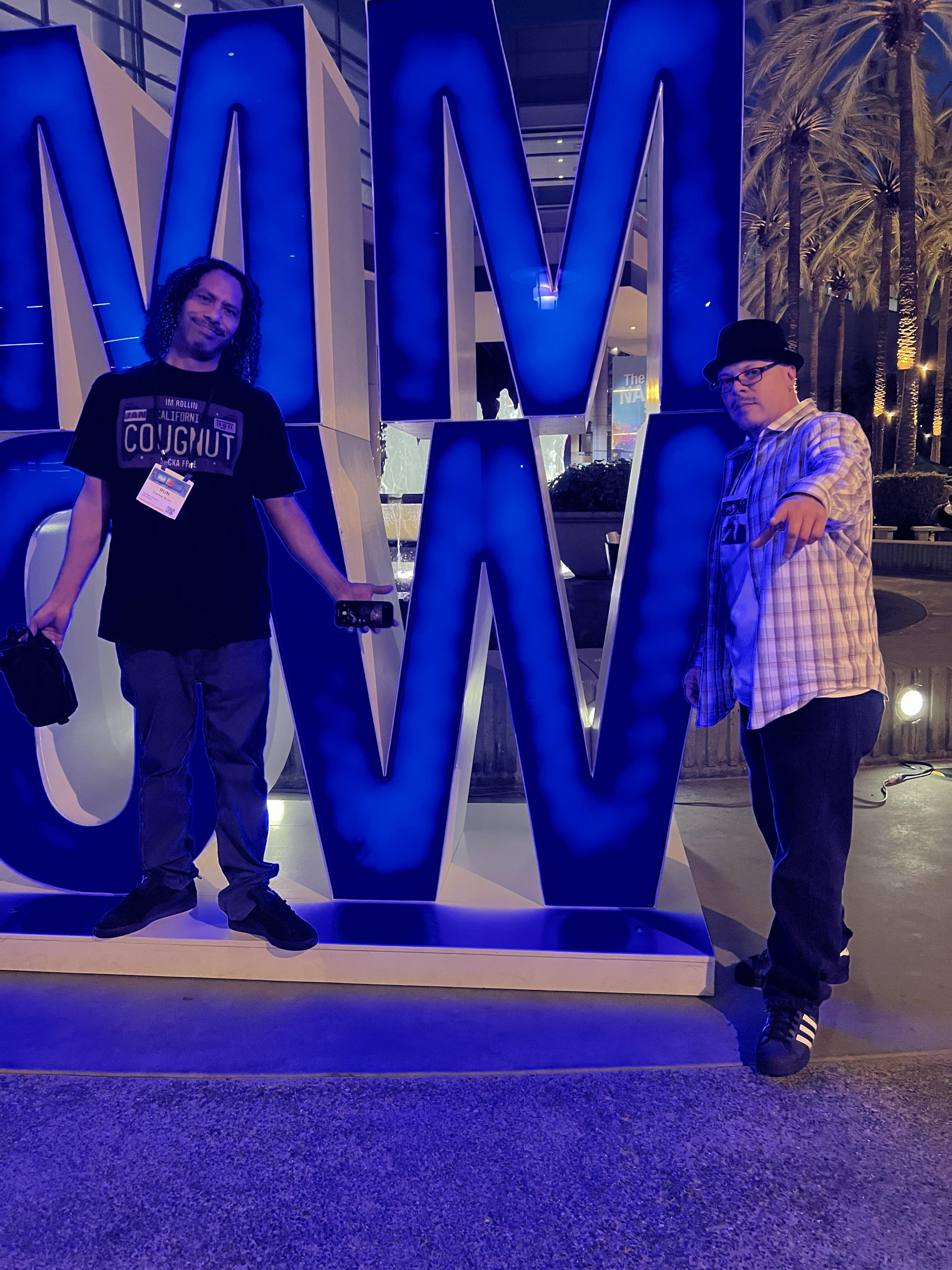 Group in front on NAMM logo.