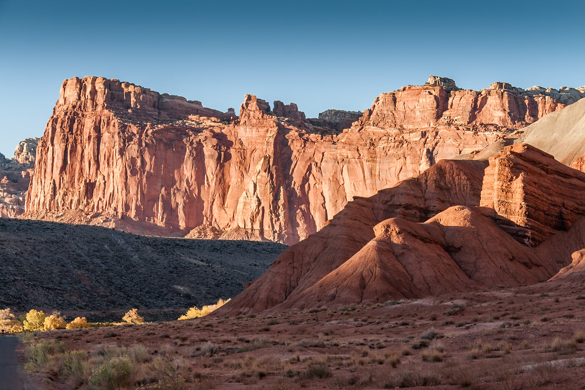 Sunset at at red rocks and some yellow trees from autumn at 'Scenic Drive' in Capitol Reef Nat'l Park, Utah, USA