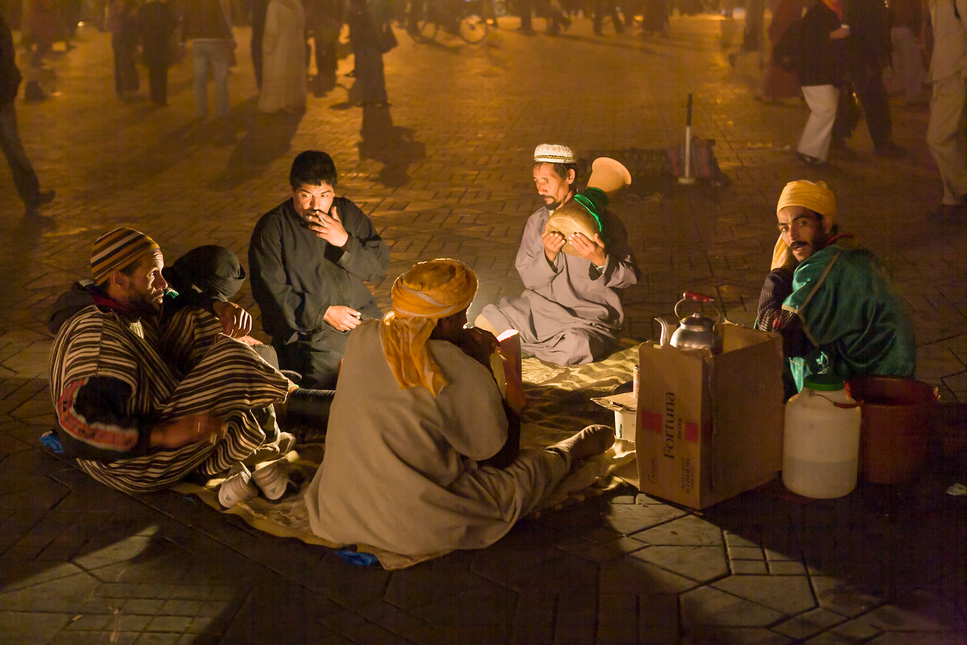 Men sitting at night at Place Djamaa El Fna at Marrakech