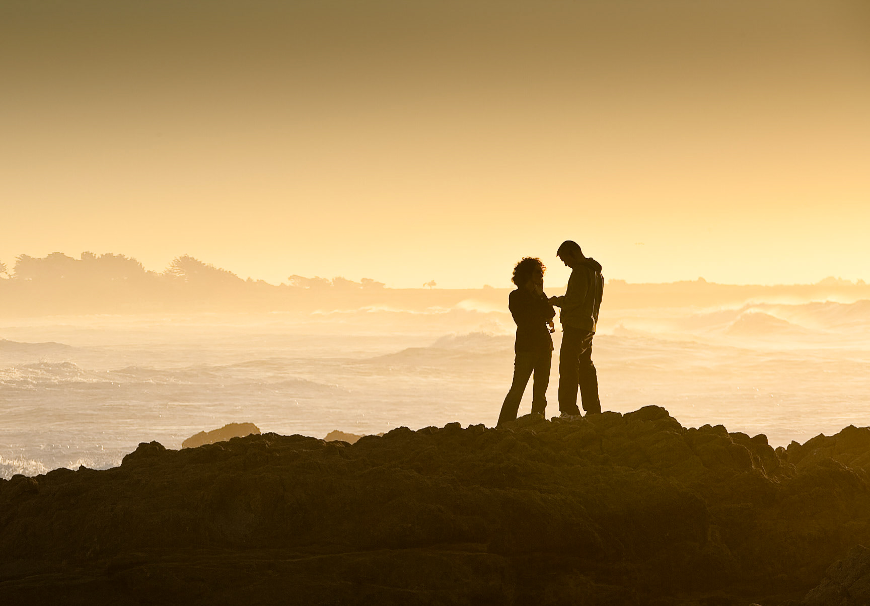 Young couple at Sunset at Asilomar State Beach near Monterey, California, USA