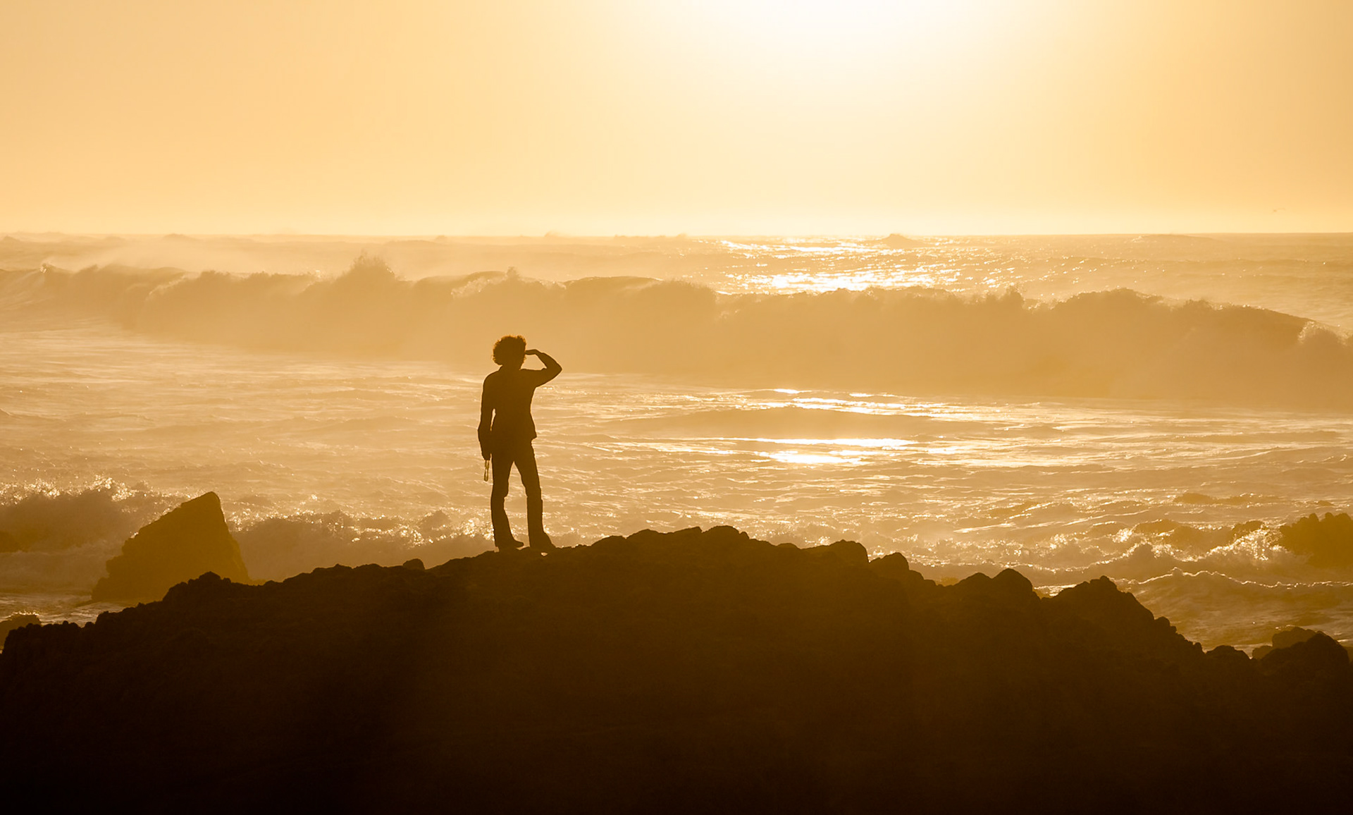 Woman at Asilomar State Beach looking to the horizon near Monterey, California, USA