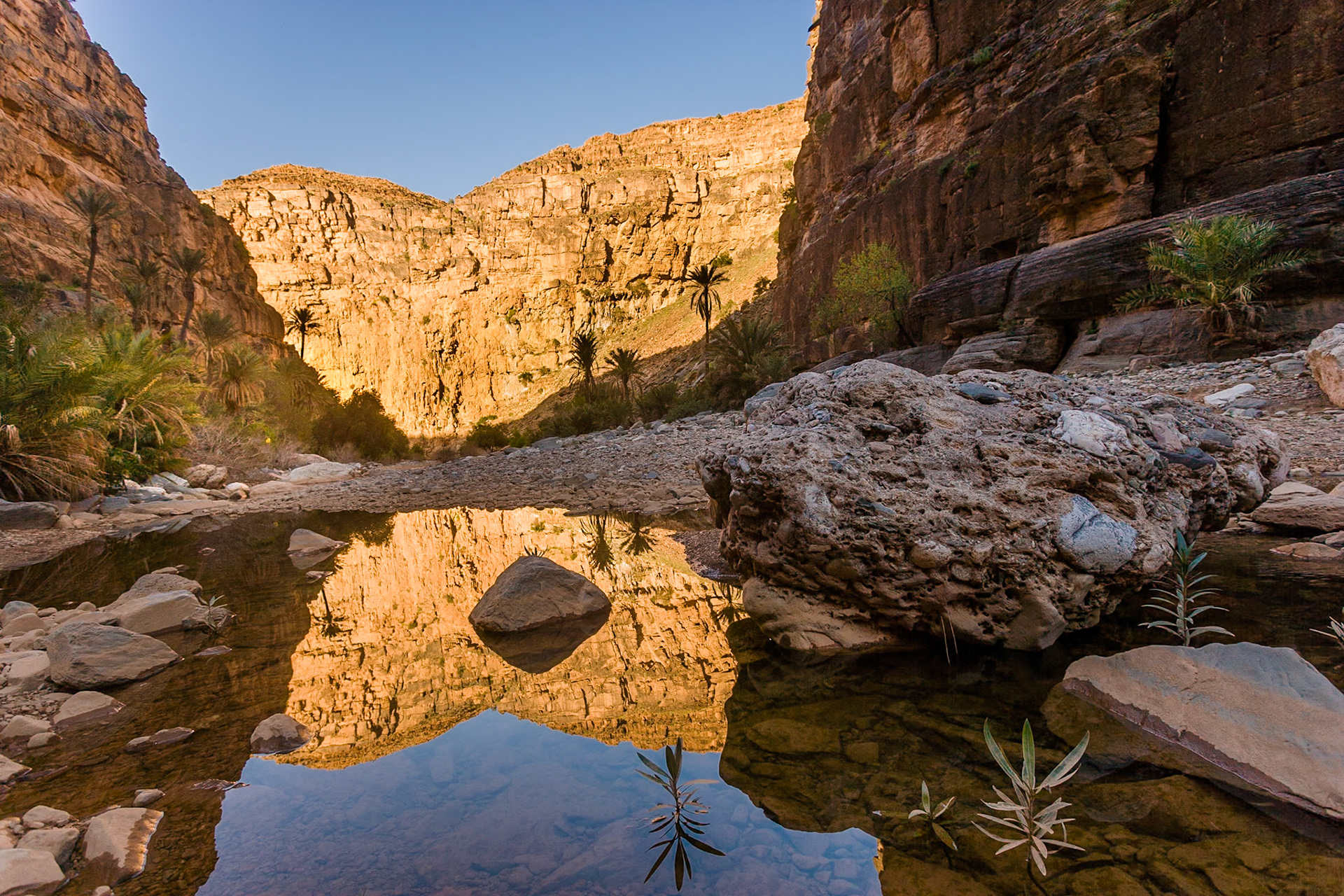 Reflection of sun lit rocks in the river in the Valley  at Amtoudi at sunset