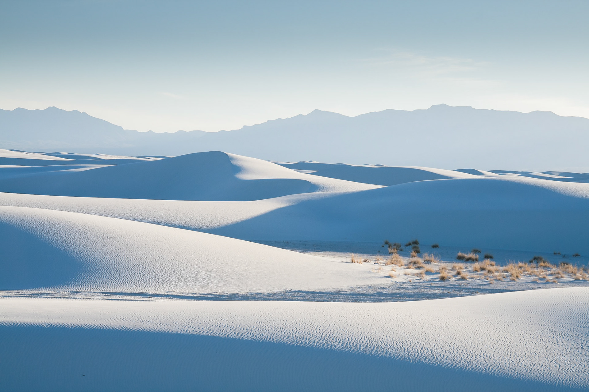 Sloping blueish dunes at White Sand Dunes National Monument, New Mexico, USA