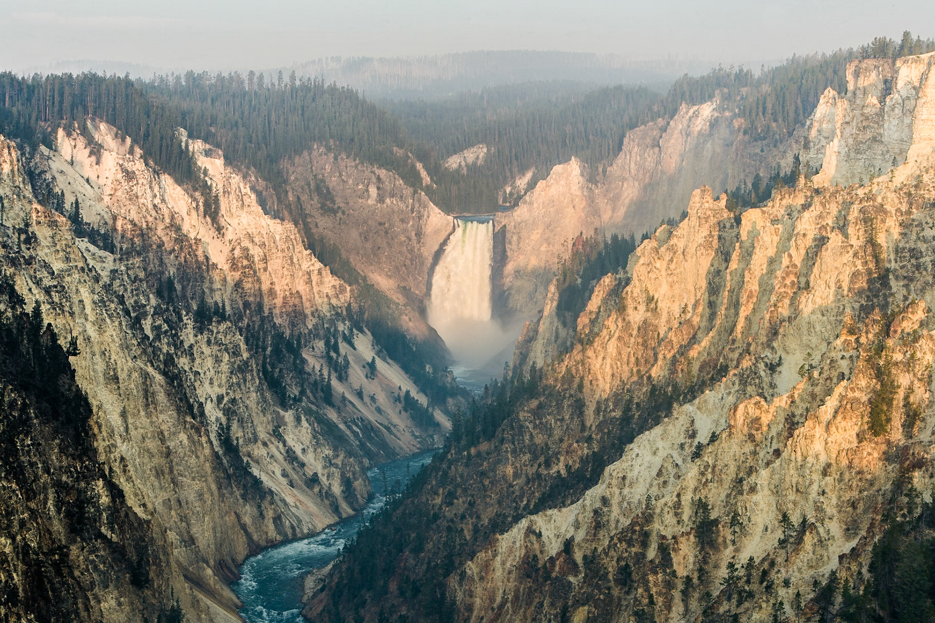 Sunrise through the smoke of forest fire in the Grand Canyon of Yellowstone National Park, Wyoming, USA