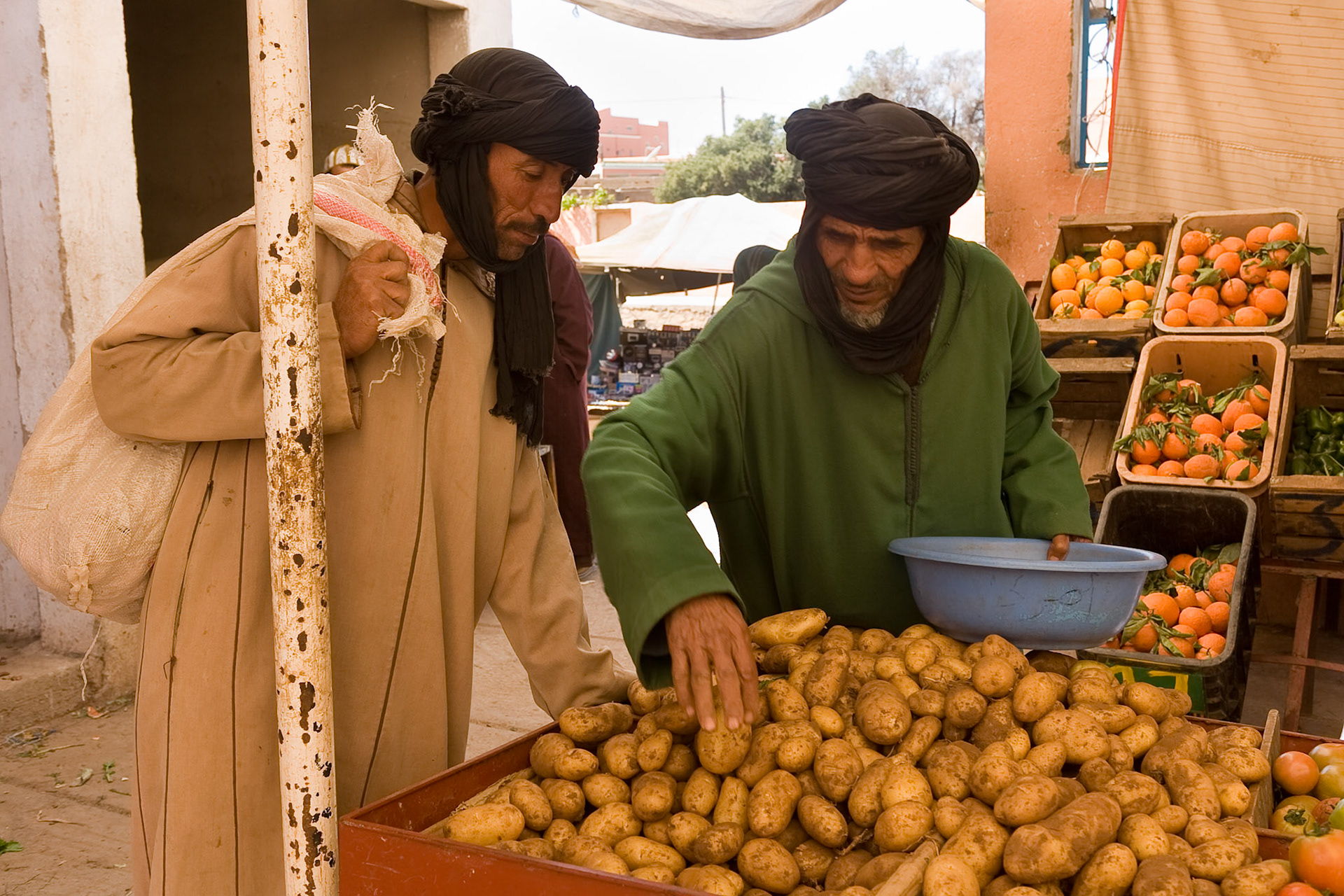 Men looking for potatous at market Tafraoute