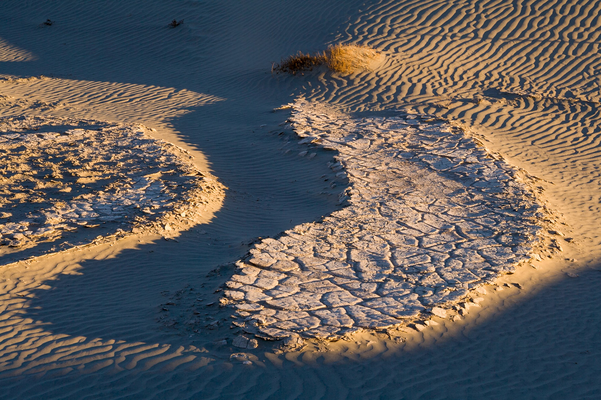 Sunset at Crusted mud at Mesquite Flat Sand Dunes, Death Valley, California, USA