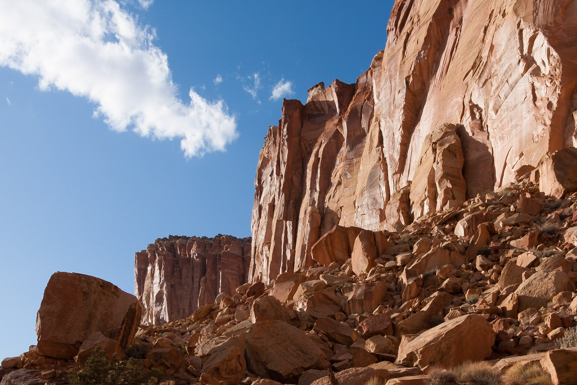 Red rocks and blue sky with a white cloud at Grand Wash in Capitol Reef Nat'l Park, Utah, USA