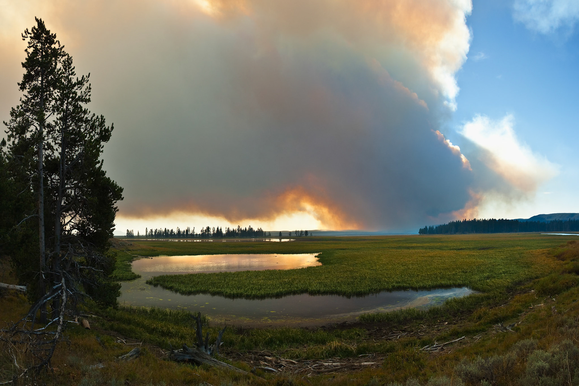 Forest Fire Smoke at the horizon of Hayden Valley with Trout Spring, yellowstone National Park, WY, USA