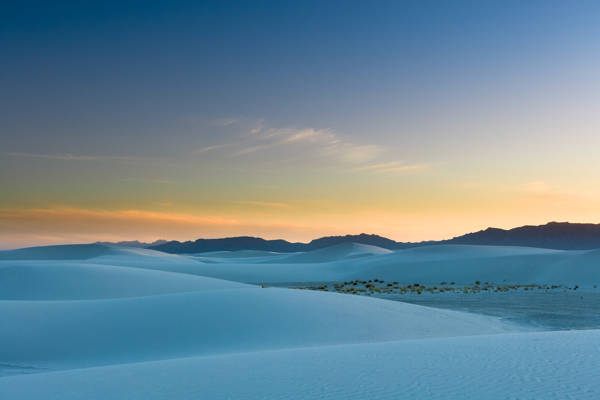 Sunset with warm to blue sky and a blue cast on the sand at White Sand Dunes National Monument, New Mexico, USA